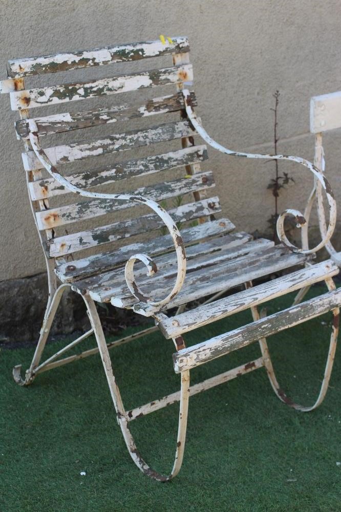 A VICTORIAN IRON STRAPWORK ARMCHAIR with slatted wood seat and back and scrolled arms and legs Image
