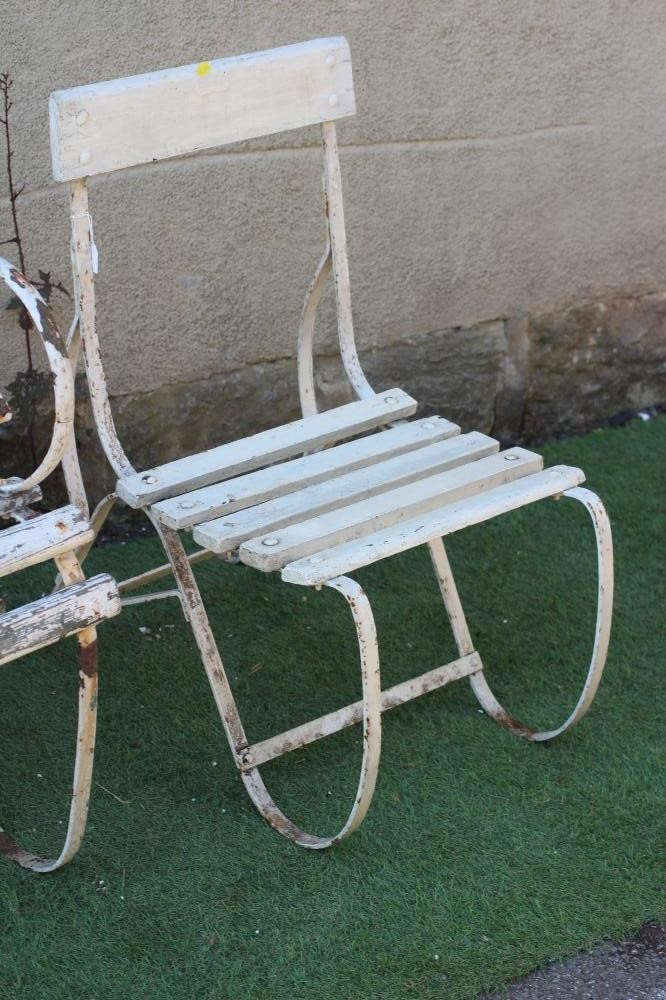 A VICTORIAN IRON STRAPWORK ARMCHAIR with slatted wood seat and back and scrolled arms and legs Image