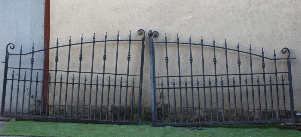 A PAIR OF IRONWORK ENTRANCE GATES, late 20th century, of arched barred form with spear finials, 81" Image