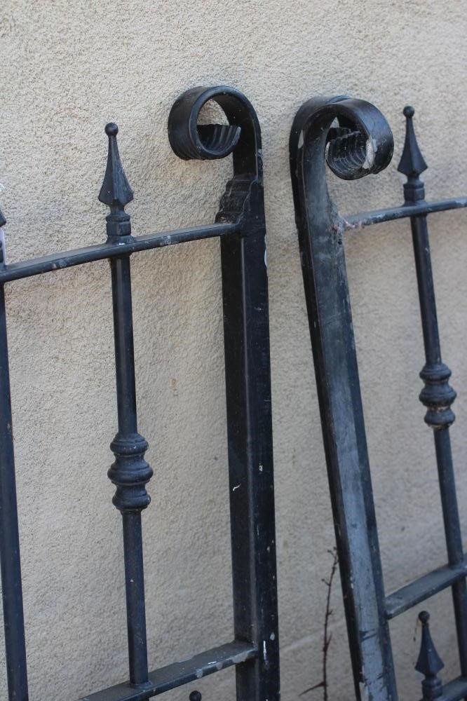 A PAIR OF IRONWORK ENTRANCE GATES, late 20th century, of arched barred form with spear finials, 81" Image