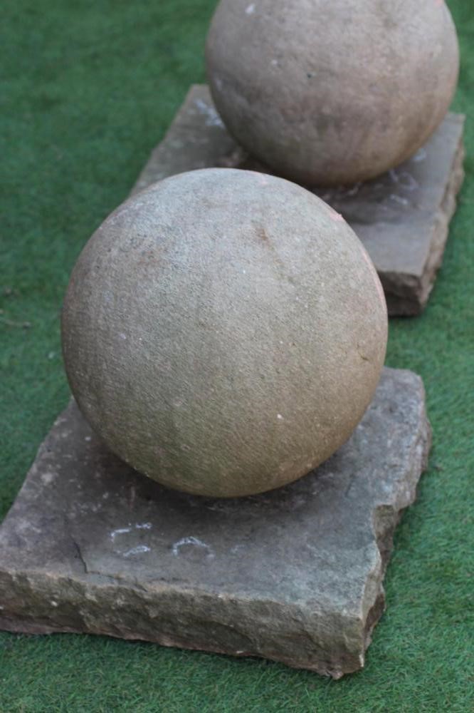 A PAIR OF SANDSTONE BALL FINIALS on square base, 16" w x 17 1/2" h (Est. plus 24% premium inc. VAT) Image