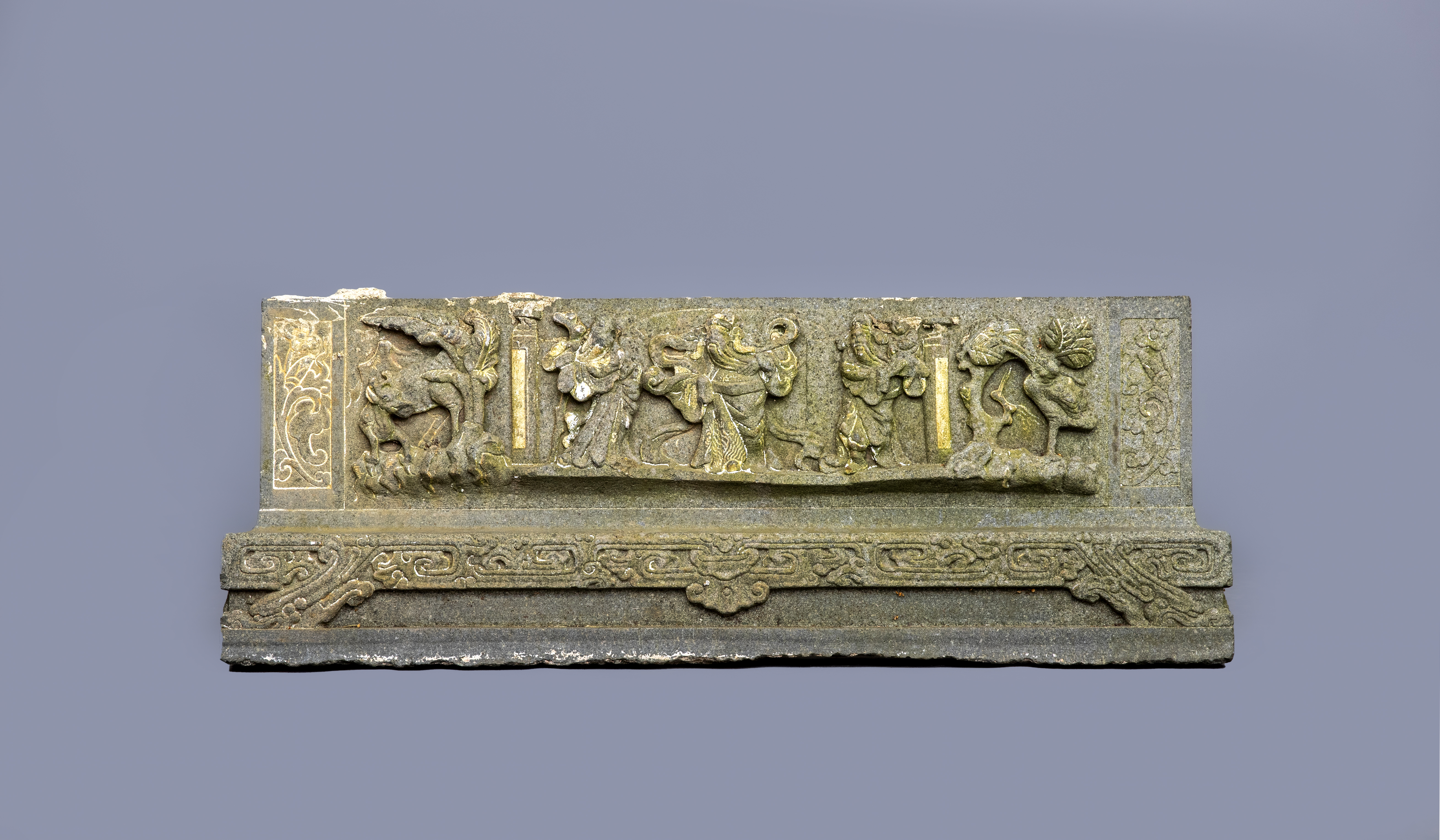 AN INDO CHINESE CARVED GRANITE(?) OBLONG TEMPLE FRIEZE PANEL with three deities flanked on one side Image