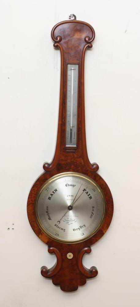 A VICTORIAN WALNUT WHEEL BAROMETER Image