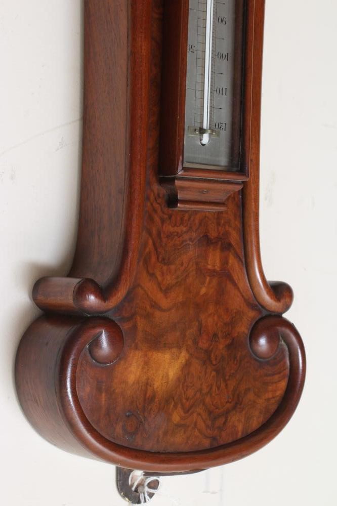 A VICTORIAN WALNUT WHEEL BAROMETER Image