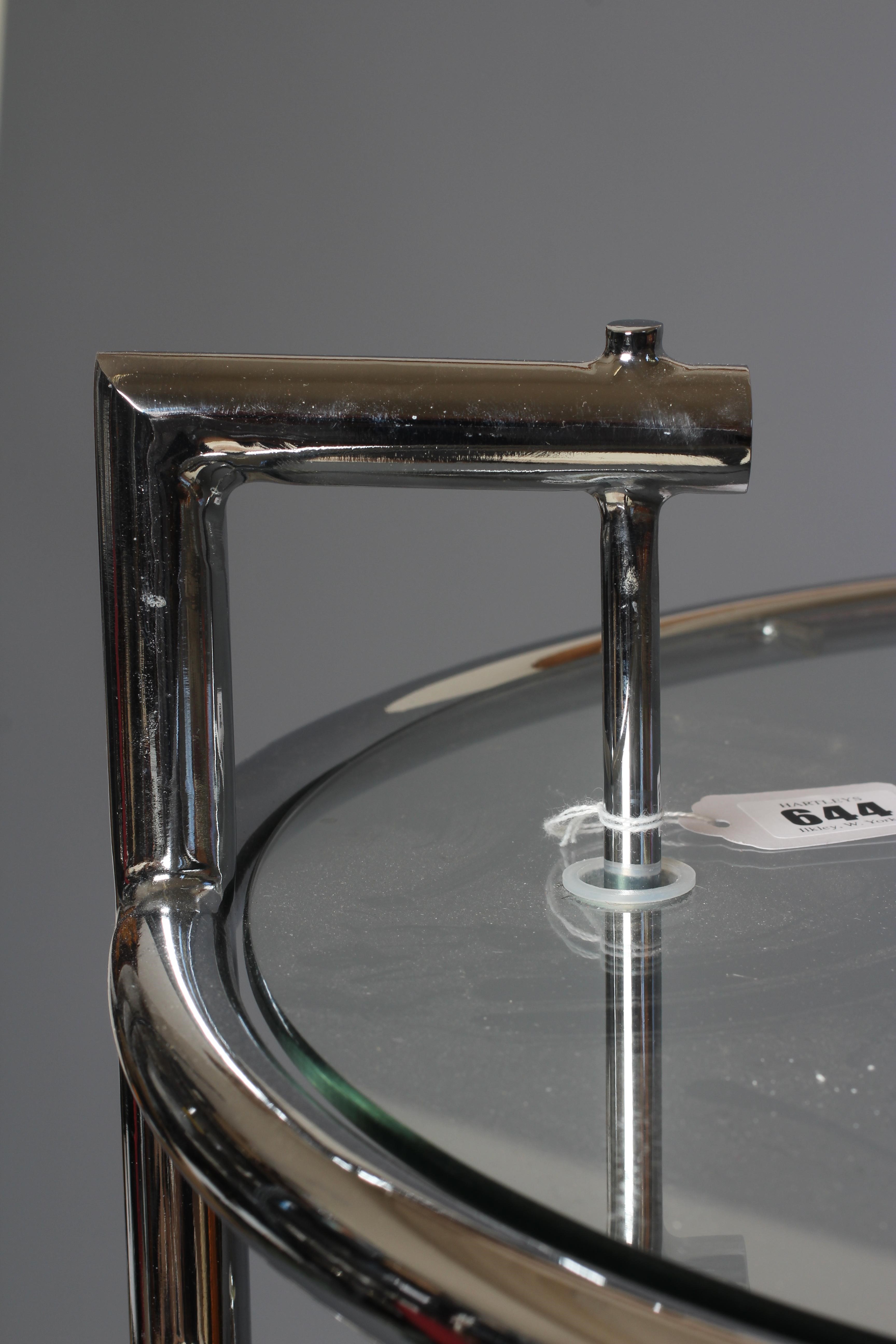 AFTER EILEEN GRAY - AN ADJUSTABLE E1027 SIDE TABLE, modern, the chromed steel frame supporting a Image