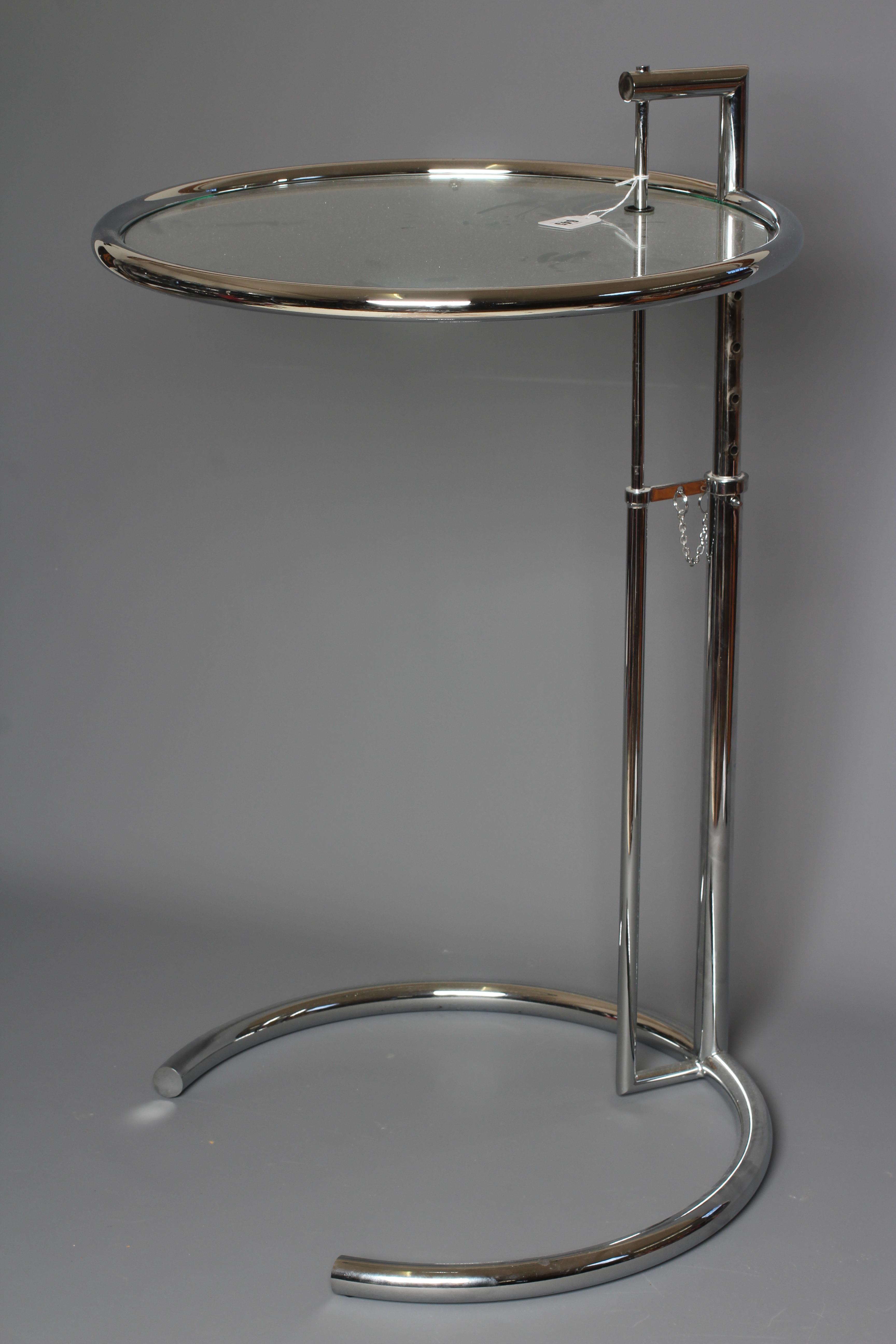 AFTER EILEEN GRAY - AN ADJUSTABLE E1027 SIDE TABLE, modern, the chromed steel frame supporting a Image