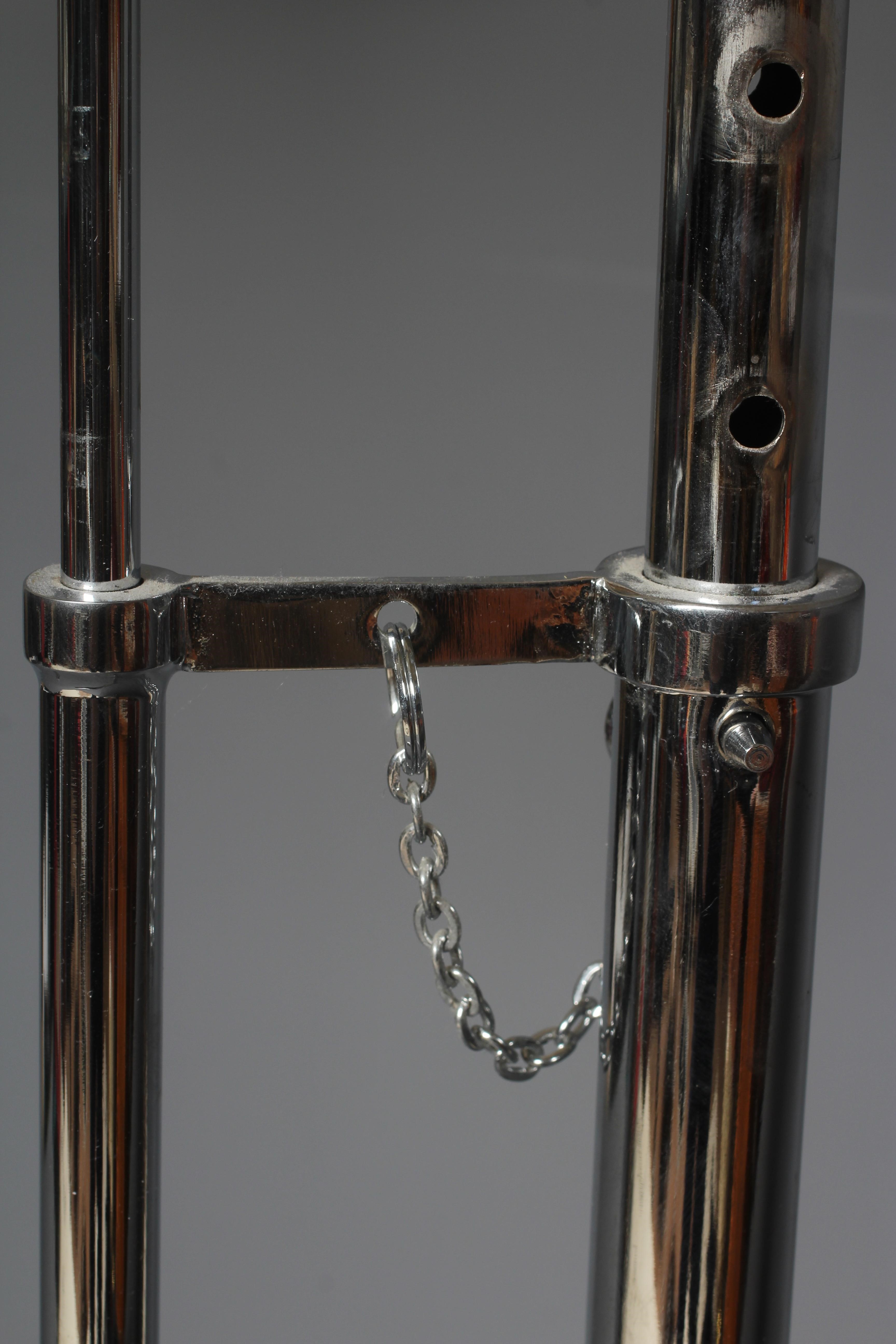 AFTER EILEEN GRAY - AN ADJUSTABLE E1027 SIDE TABLE, modern, the chromed steel frame supporting a Image