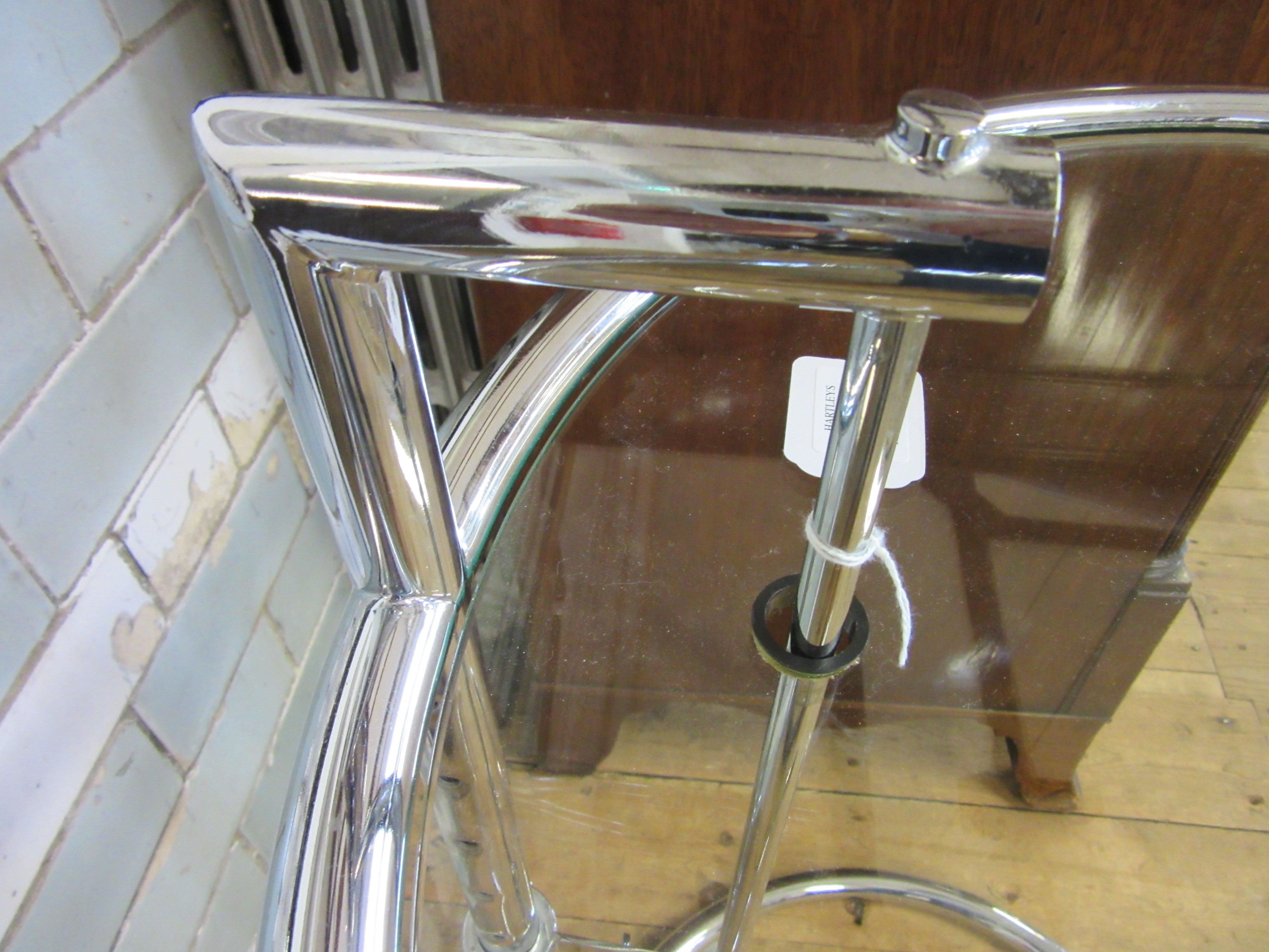 AFTER EILEEN GRAY - AN ADJUSTABLE E1027 SIDE TABLE, modern, the chromed steel frame supporting a Image