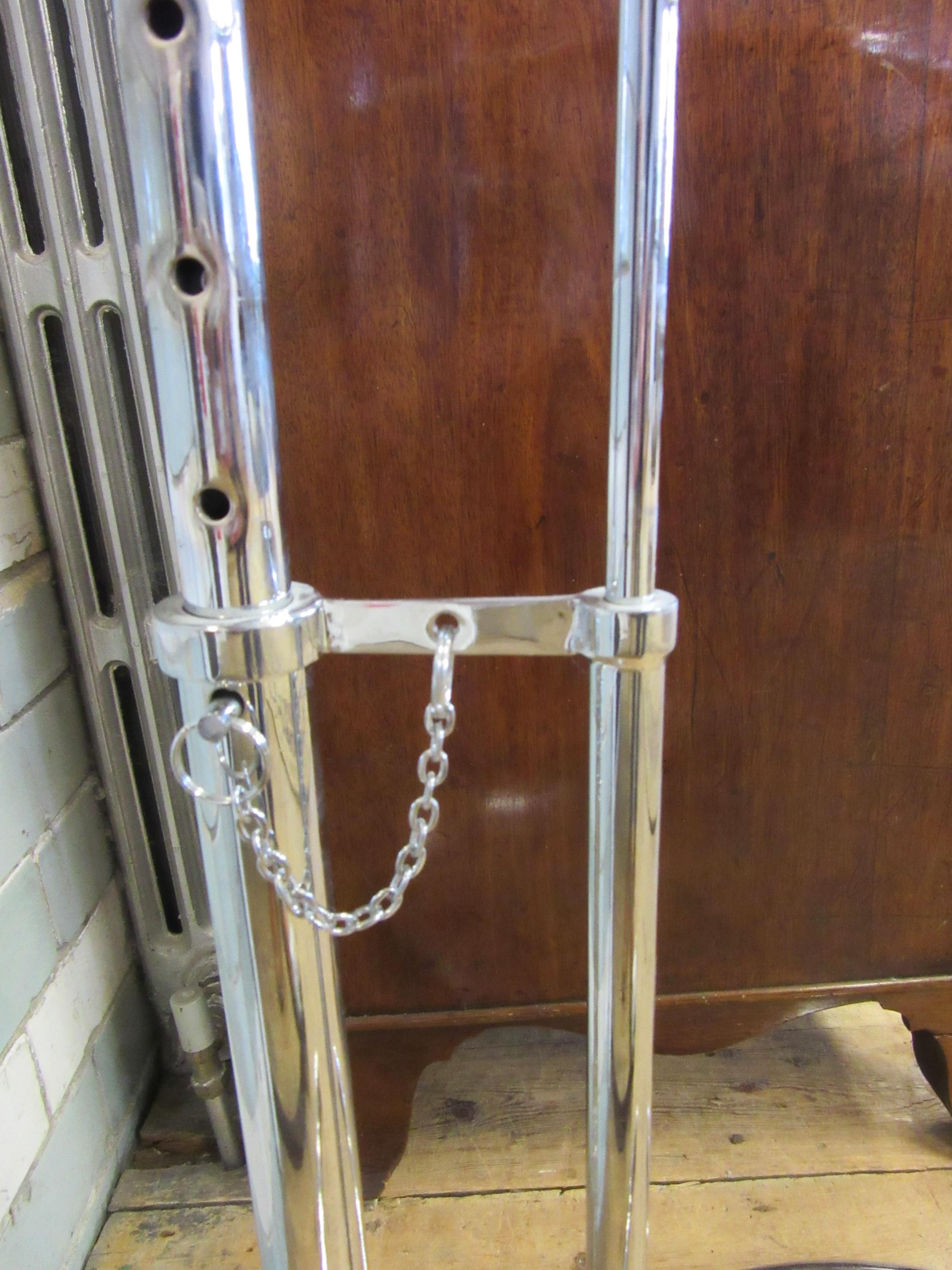 AFTER EILEEN GRAY - AN ADJUSTABLE E1027 SIDE TABLE, modern, the chromed steel frame supporting a Image