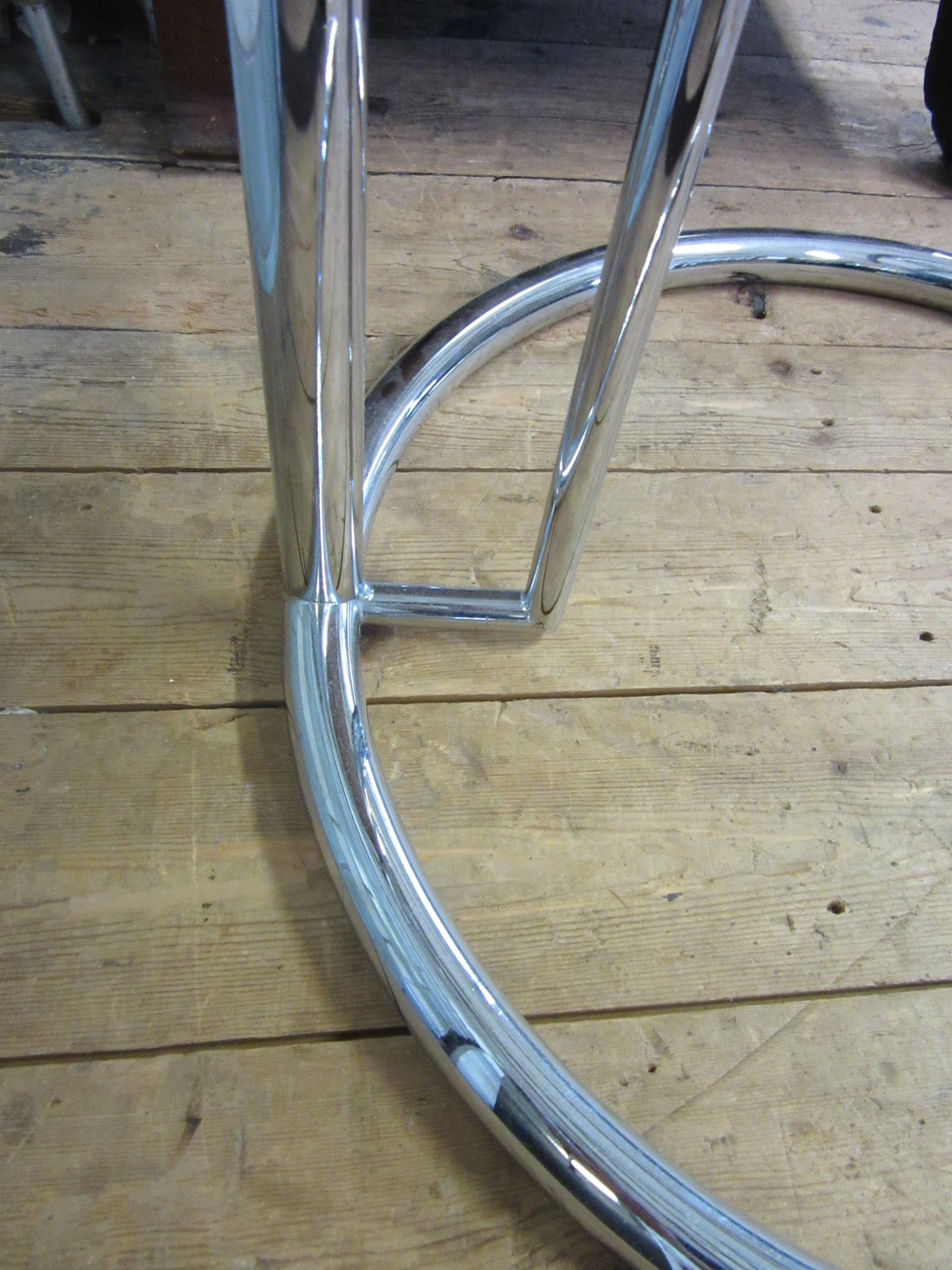 AFTER EILEEN GRAY - AN ADJUSTABLE E1027 SIDE TABLE, modern, the chromed steel frame supporting a Image