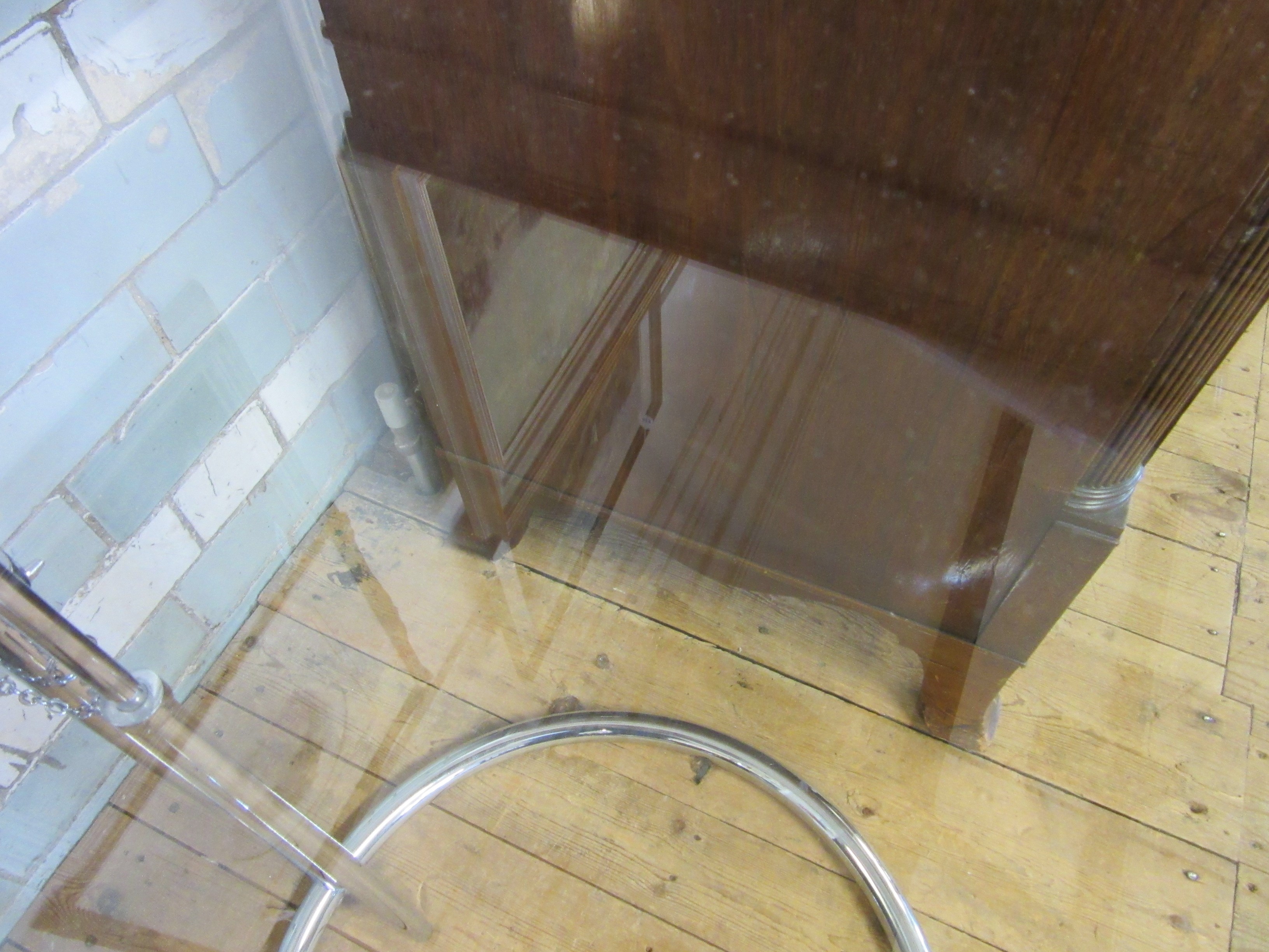 AFTER EILEEN GRAY - AN ADJUSTABLE E1027 SIDE TABLE, modern, the chromed steel frame supporting a Image