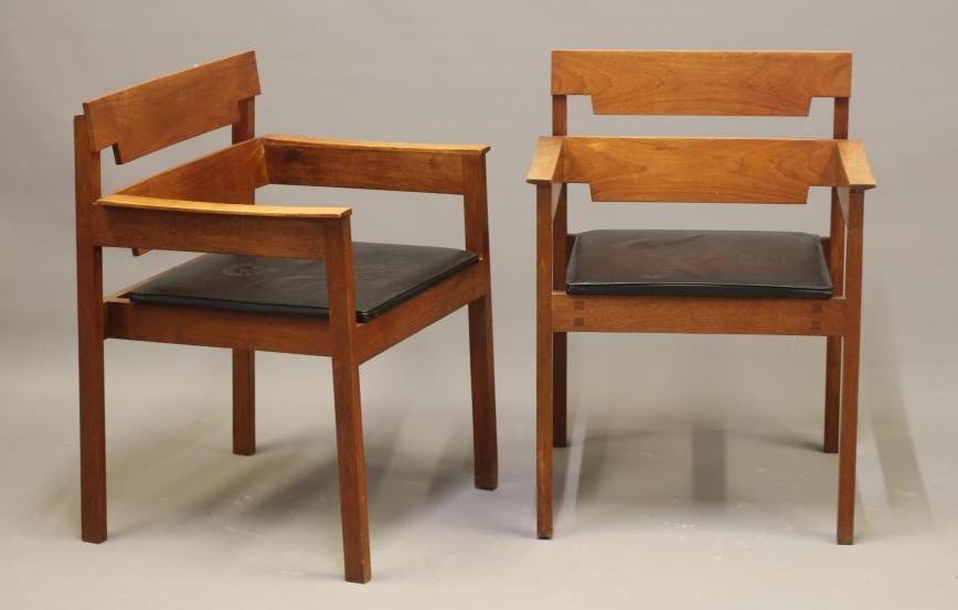 A PAIR OF TEAK ELBOW CHAIRS Image