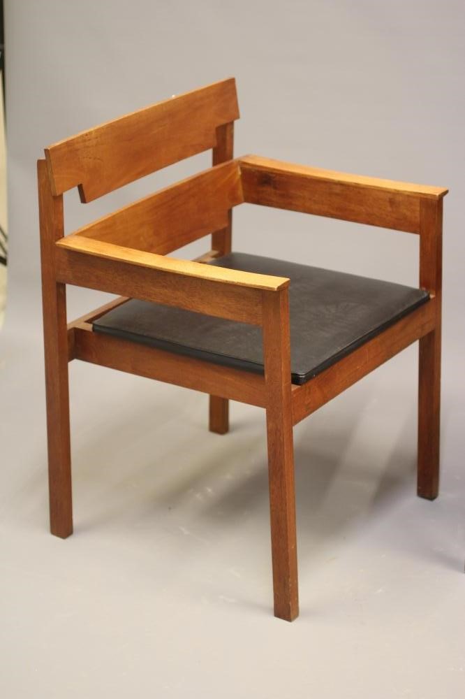 A PAIR OF TEAK ELBOW CHAIRS Image