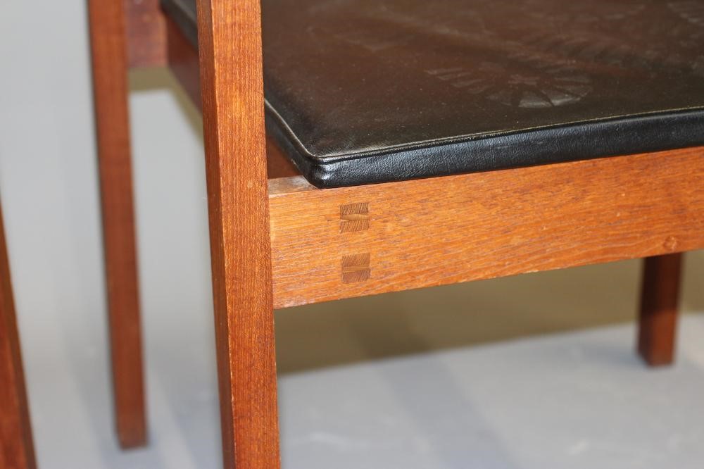A PAIR OF TEAK ELBOW CHAIRS Image
