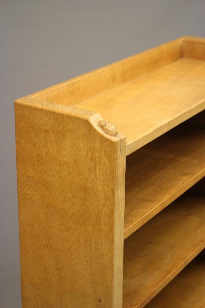 A ROBERT THOMPSON ADZED OAK OPEN BOOKCASE with galleried top and four adjustable shelves Image