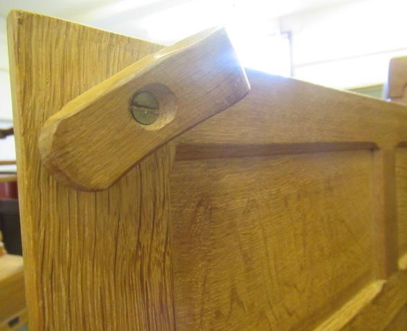 A ROBERT THOMPSON ADZED OAK DOUBLE WARDROBE of multi-panelled form with half penny moulded cornice Image