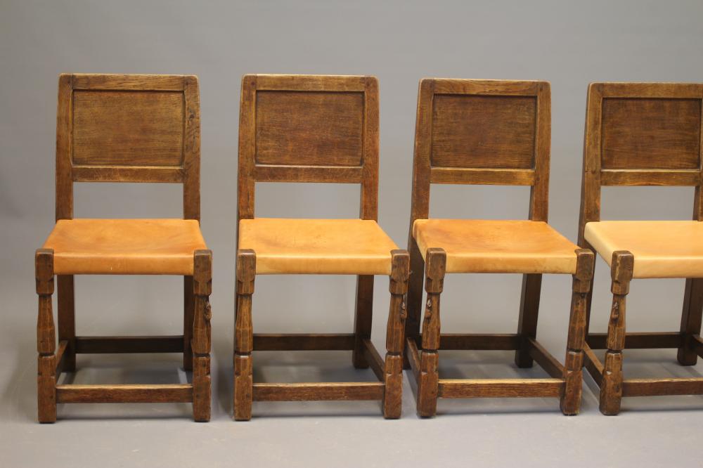 A ROBERT THOMPSON SET OF SEVEN ADZED OAK DINING CHAIRS Image