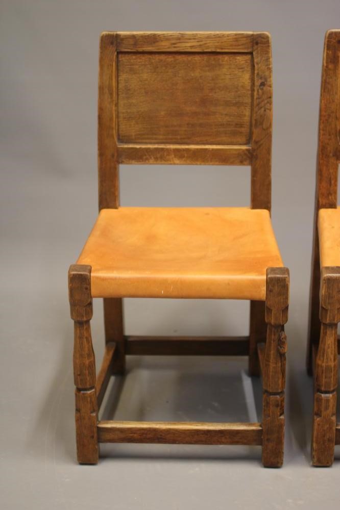 A ROBERT THOMPSON SET OF SEVEN ADZED OAK DINING CHAIRS Image