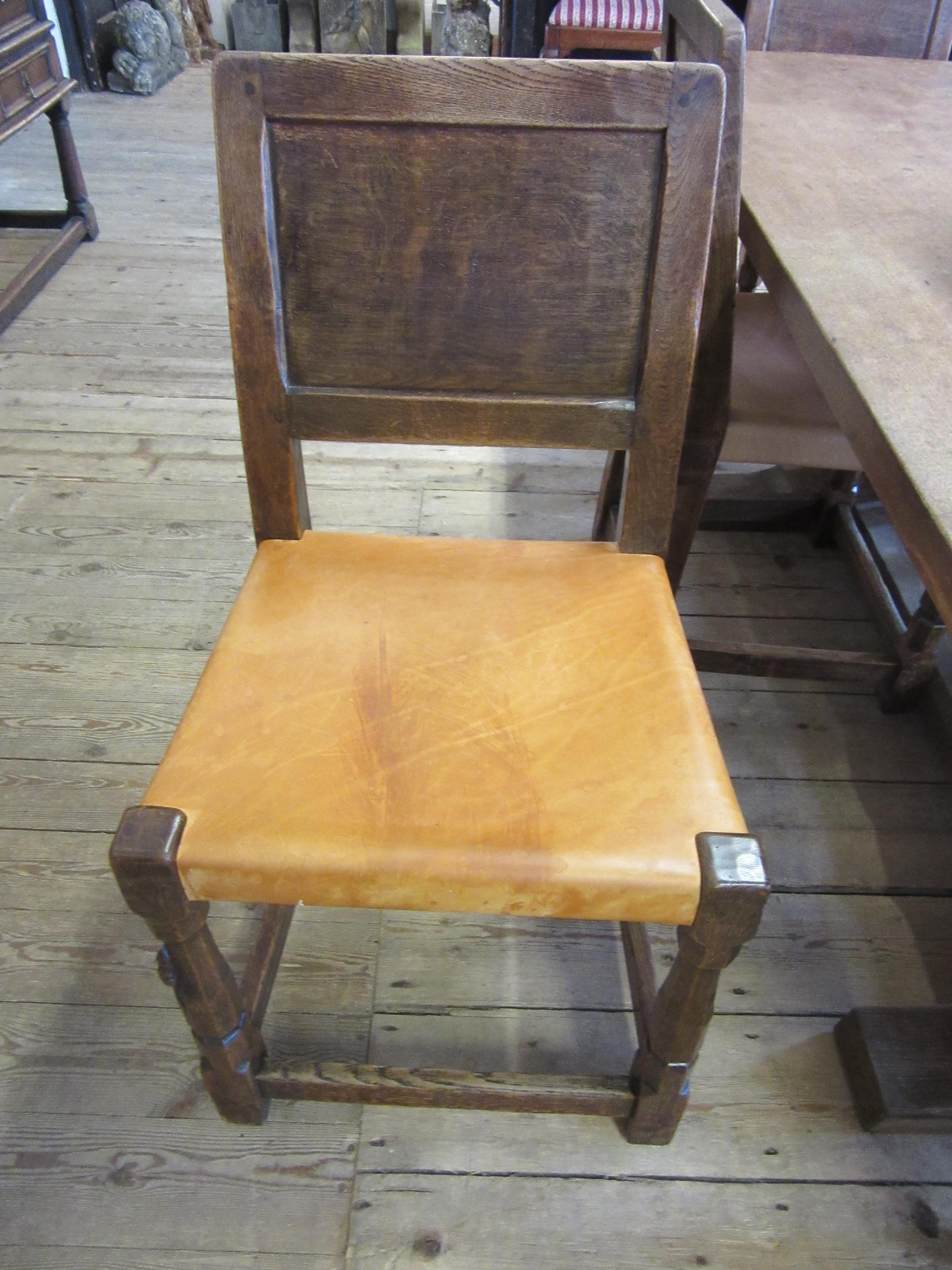 A ROBERT THOMPSON SET OF SEVEN ADZED OAK DINING CHAIRS Image