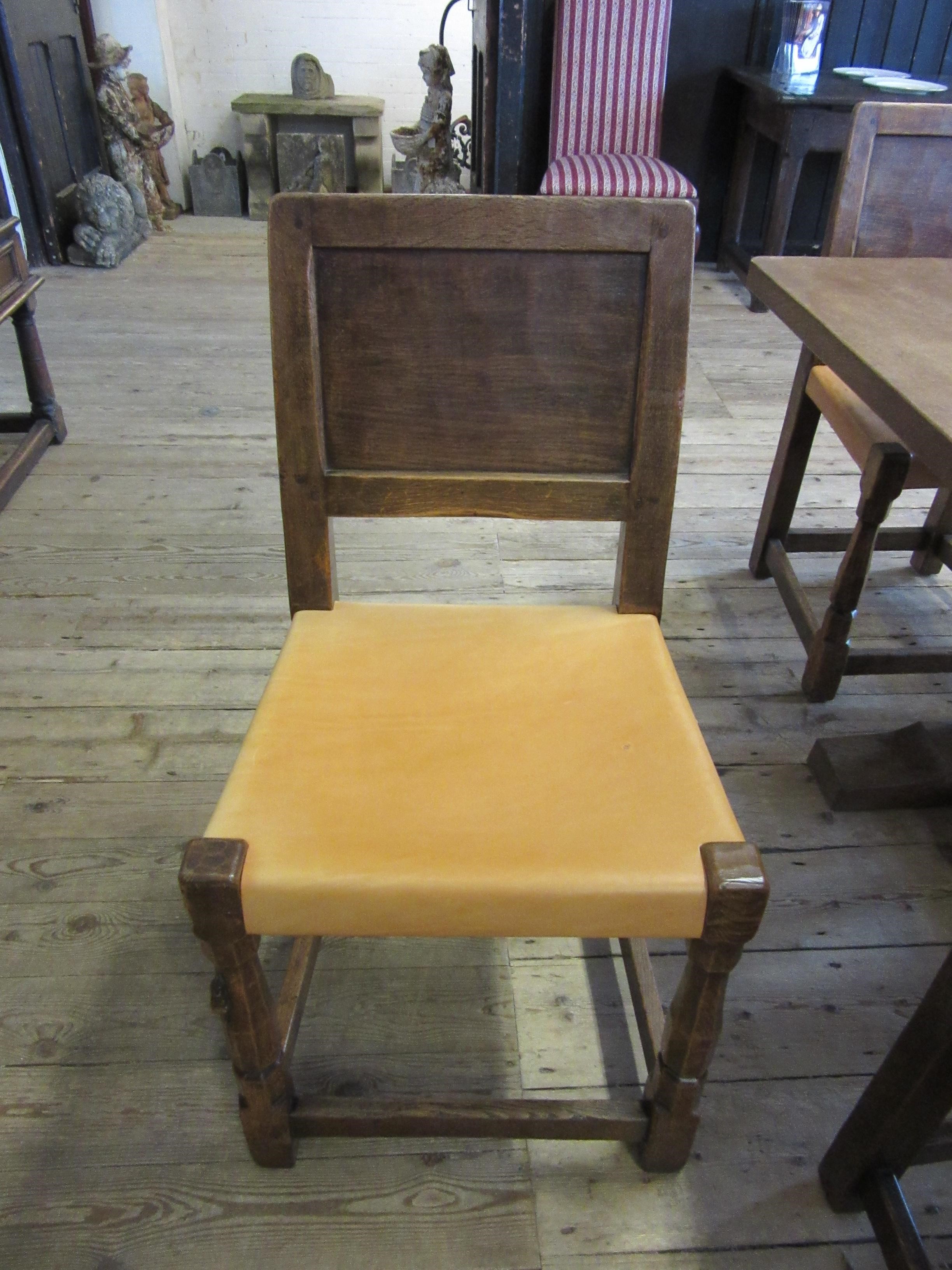 A ROBERT THOMPSON SET OF SEVEN ADZED OAK DINING CHAIRS Image