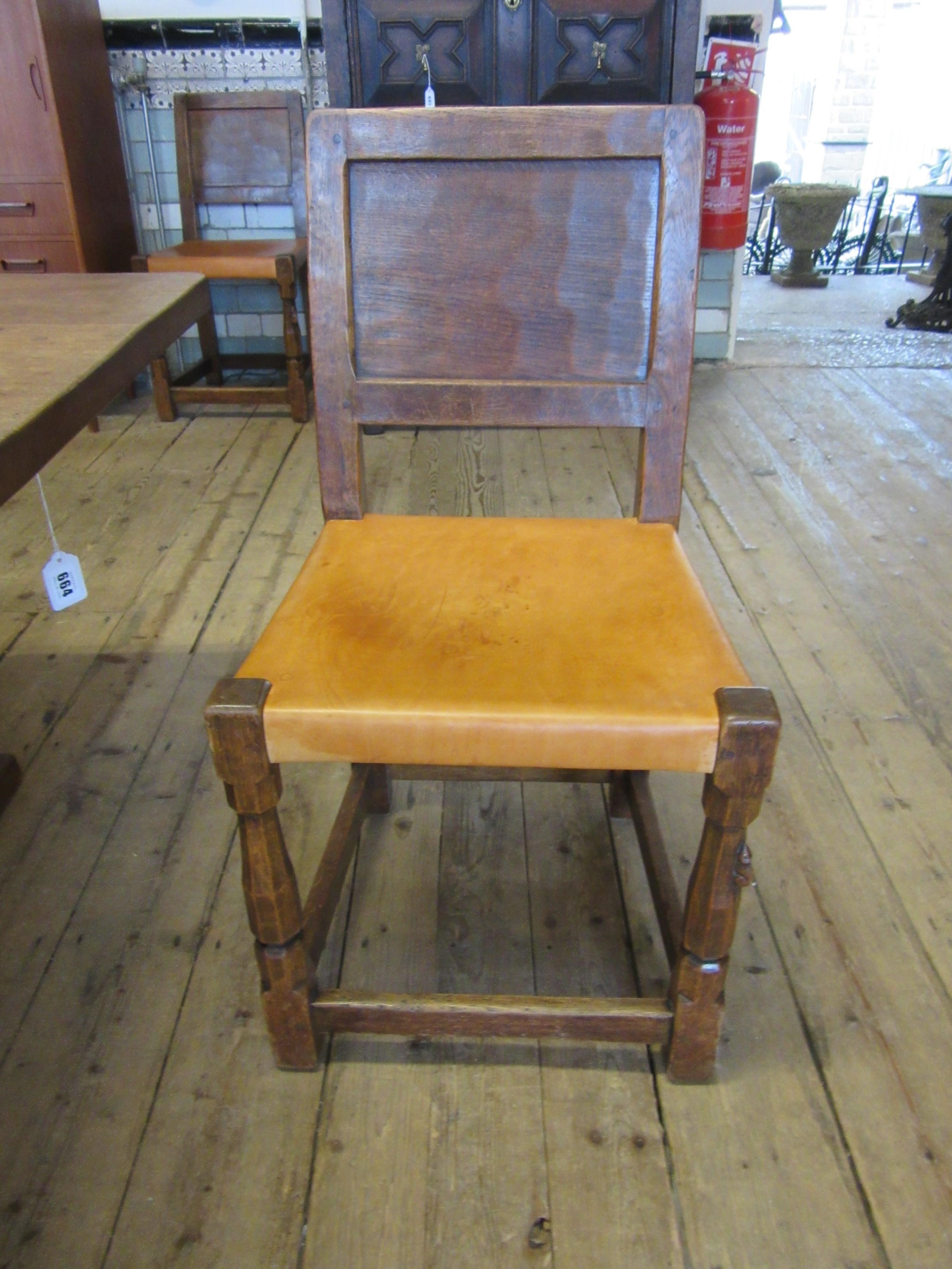 A ROBERT THOMPSON SET OF SEVEN ADZED OAK DINING CHAIRS Image