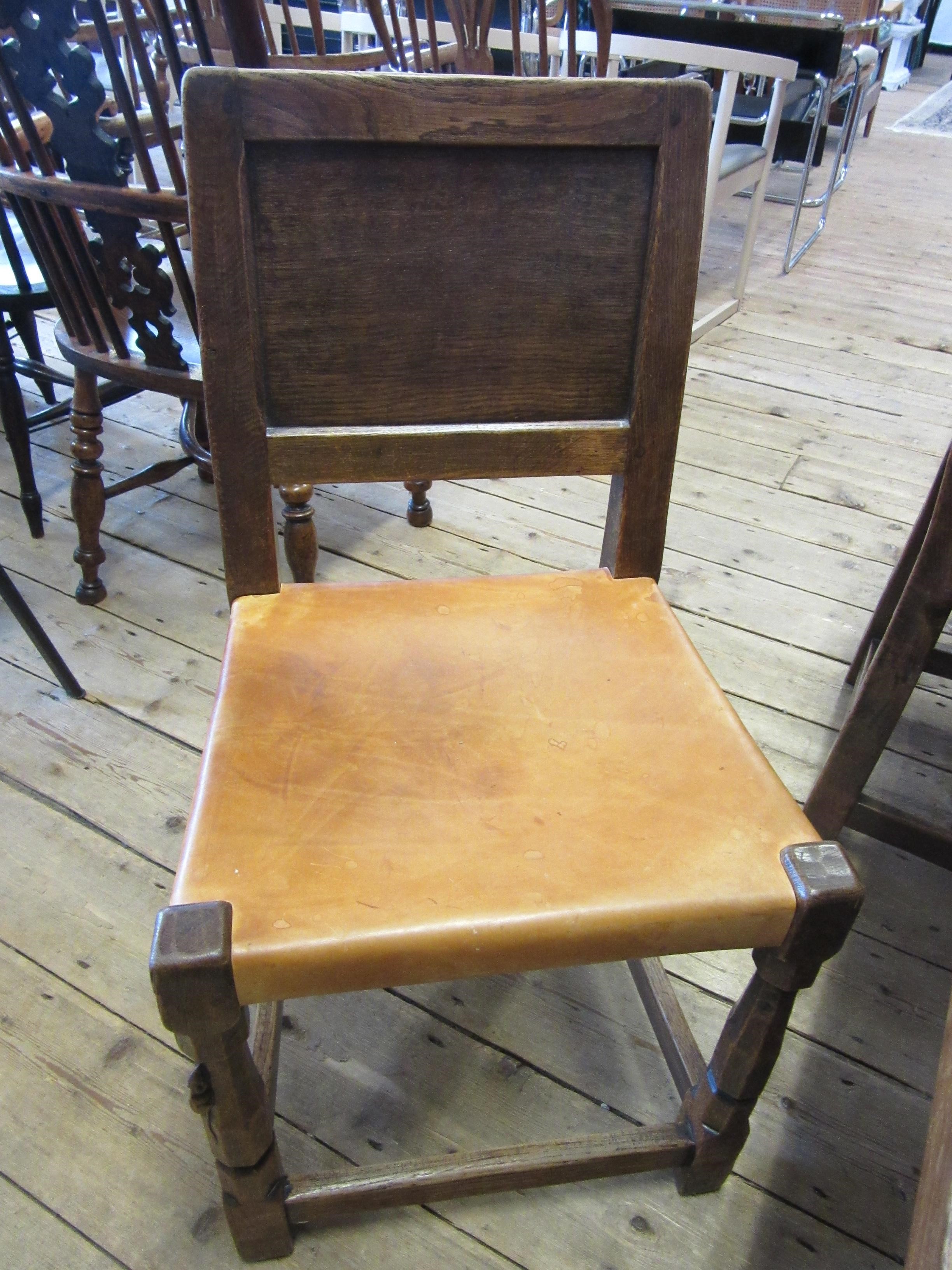 A ROBERT THOMPSON SET OF SEVEN ADZED OAK DINING CHAIRS Image