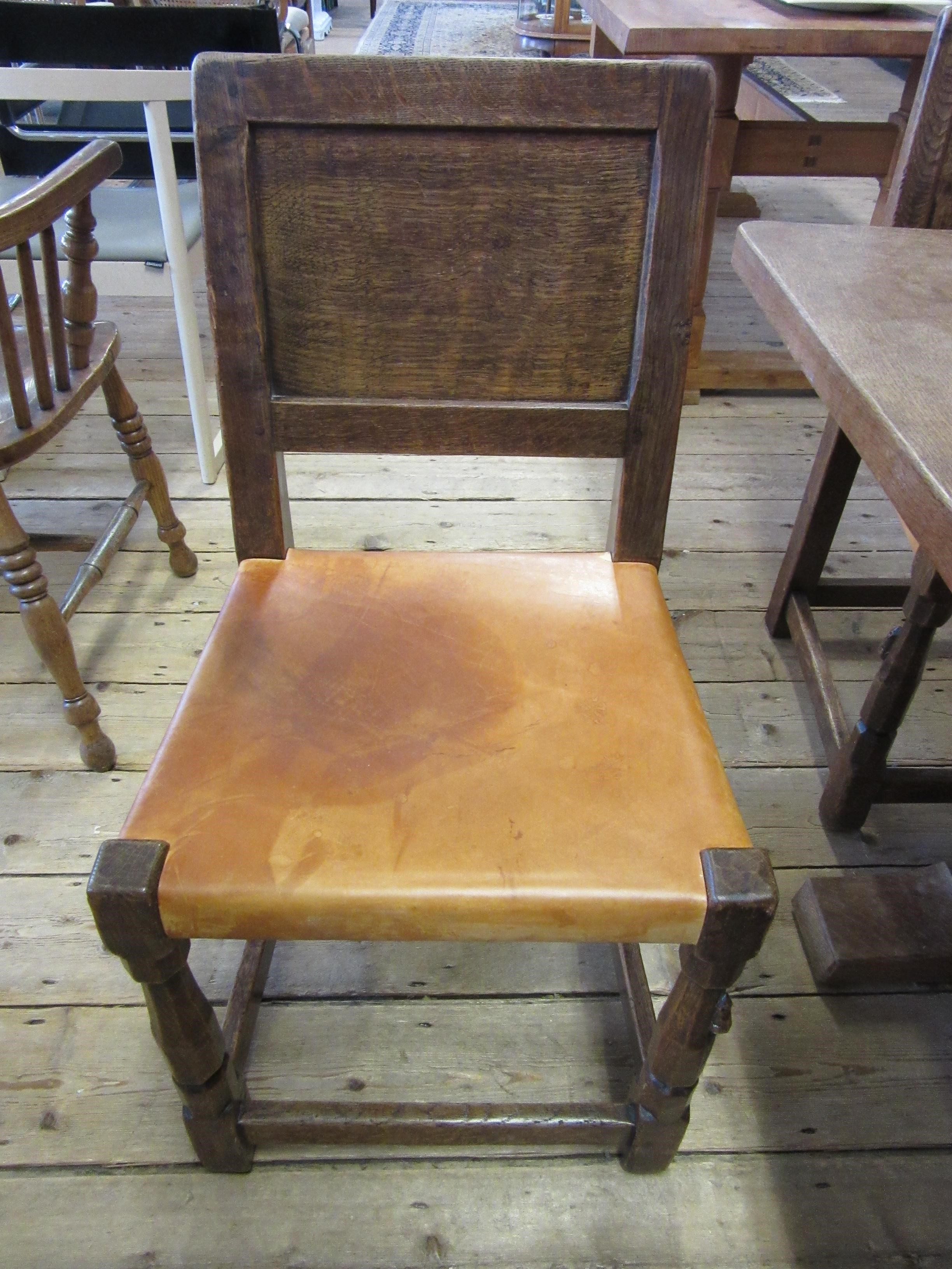 A ROBERT THOMPSON SET OF SEVEN ADZED OAK DINING CHAIRS Image