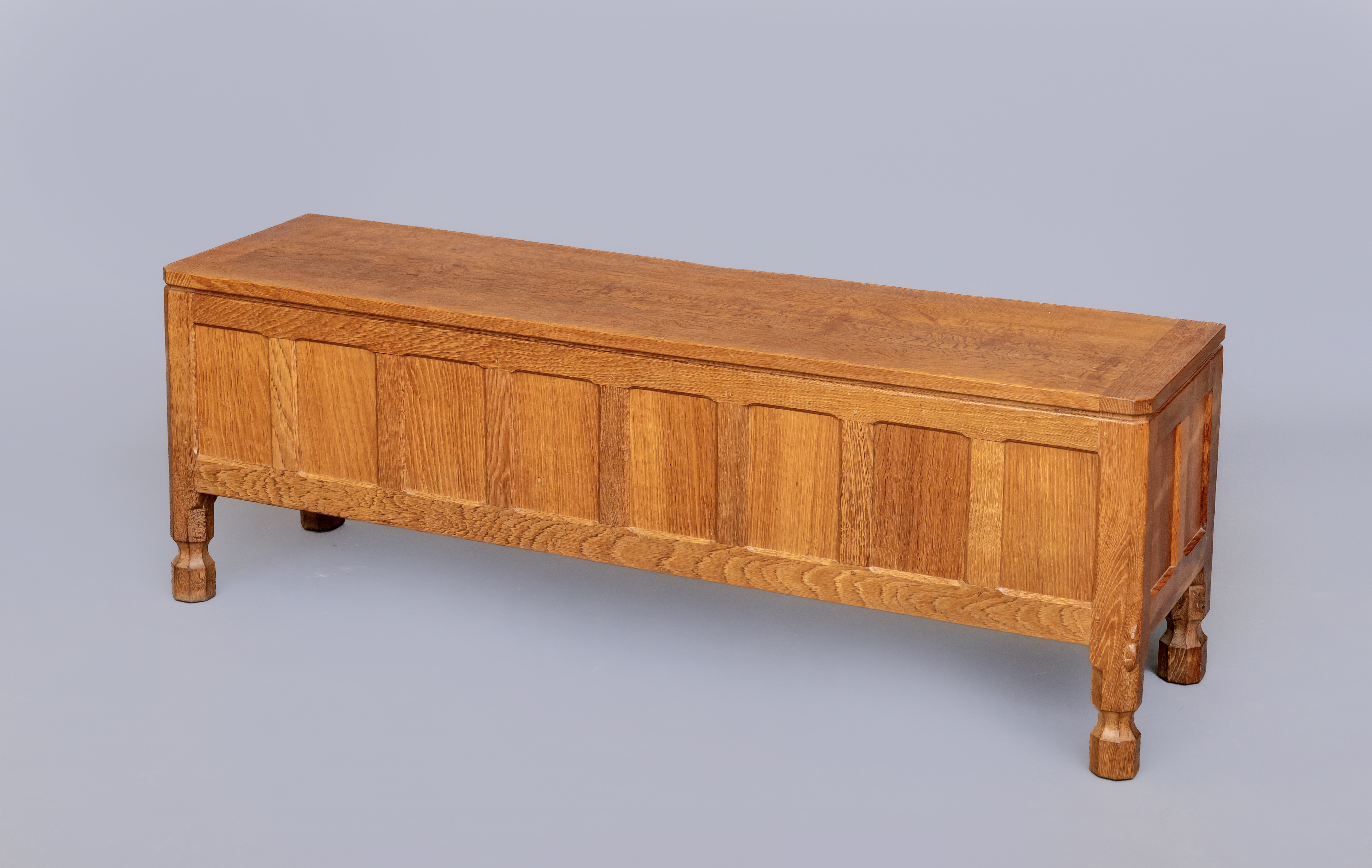A ROBERT THOMPSON ADZED OAK PANELLED BLANKET CHEST of canted oblong form Image