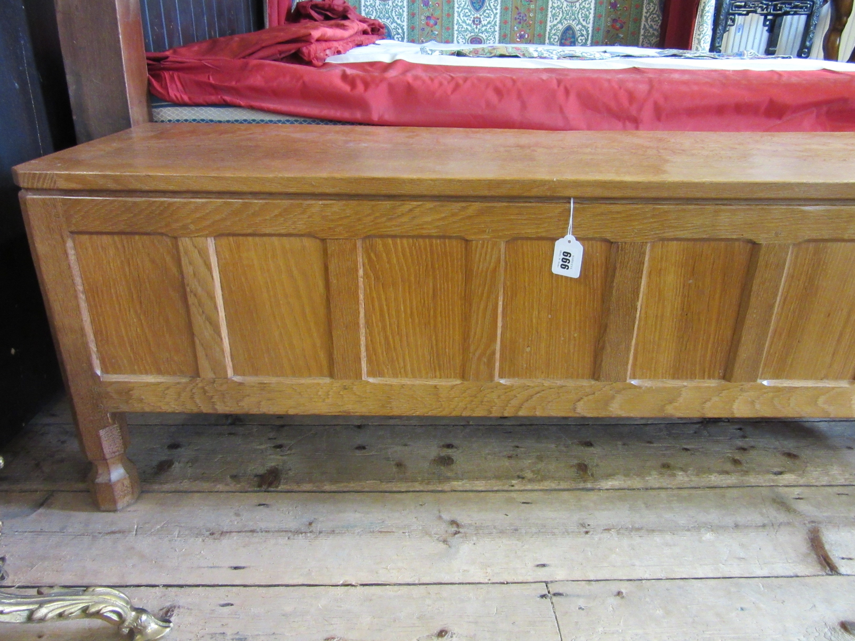 A ROBERT THOMPSON ADZED OAK PANELLED BLANKET CHEST of canted oblong form Image