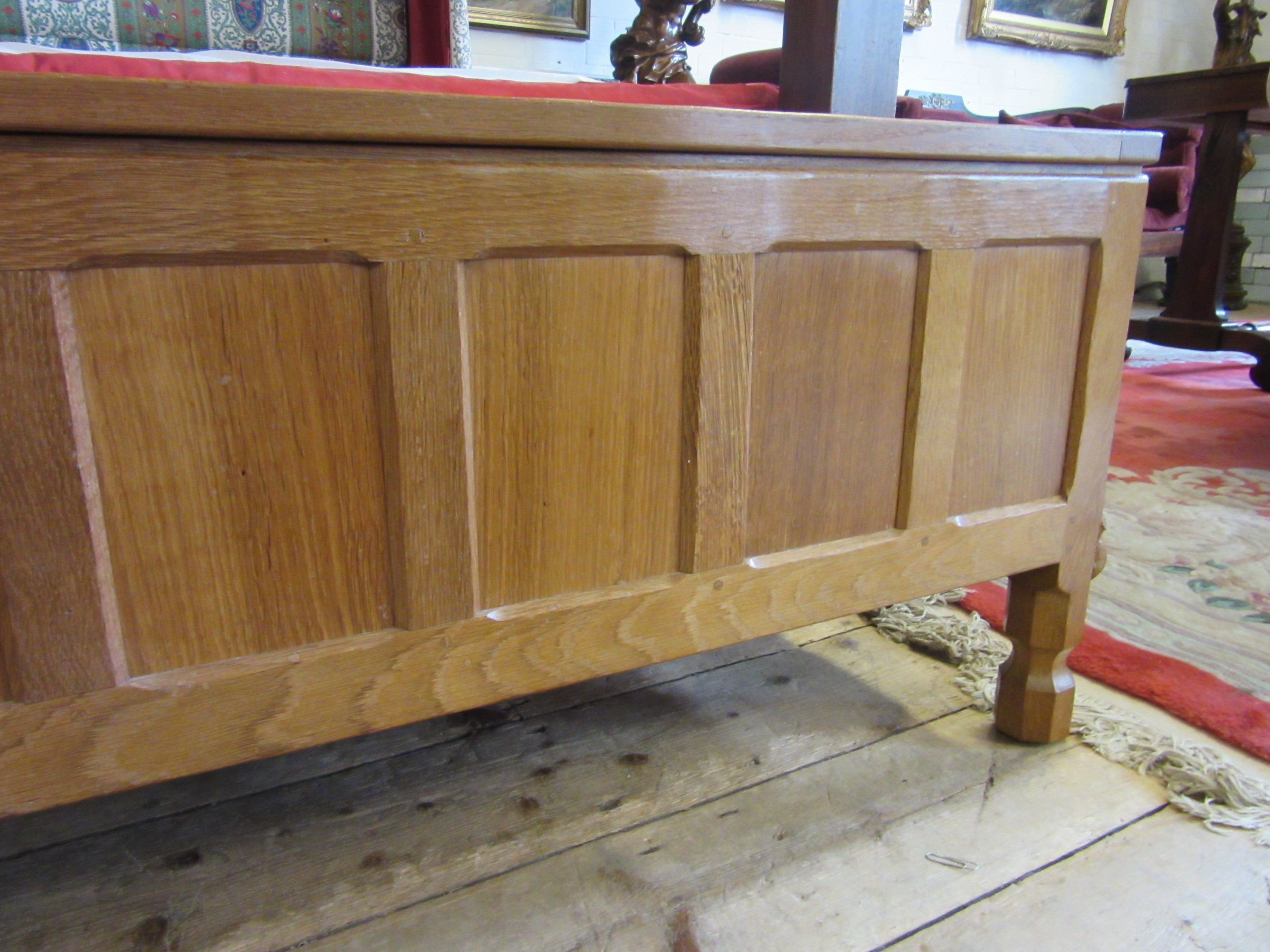 A ROBERT THOMPSON ADZED OAK PANELLED BLANKET CHEST of canted oblong form Image