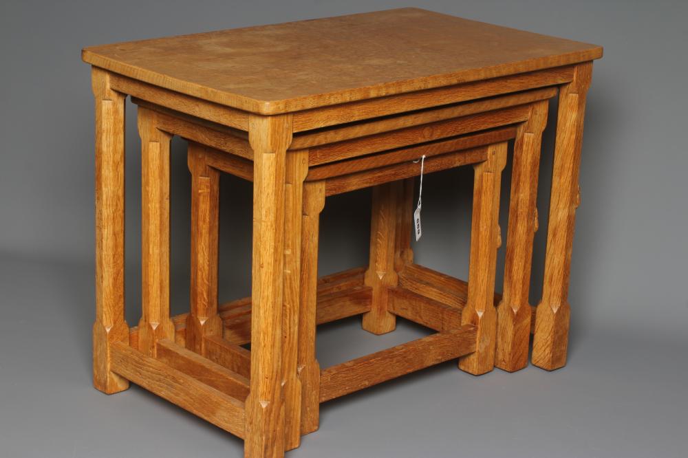 A ROBERT THOMPSON ADZED OAK NEST OF THREE TABLES Image