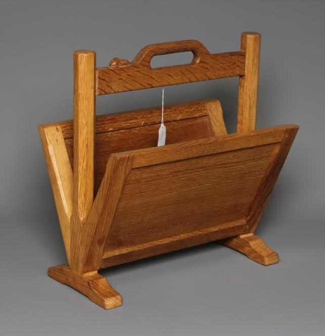 A robert thompson oak magazine rack with splayed panelled sides ...