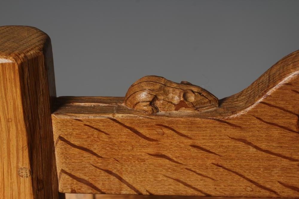 A ROBERT THOMPSON OAK MAGAZINE RACK with splayed panelled sides Image