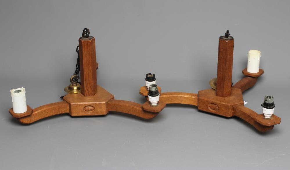 ACORN INDUSTRIES GEORGE GRAINGER - A PAIR OF OAK THREE LIGHT PENDANTS Image