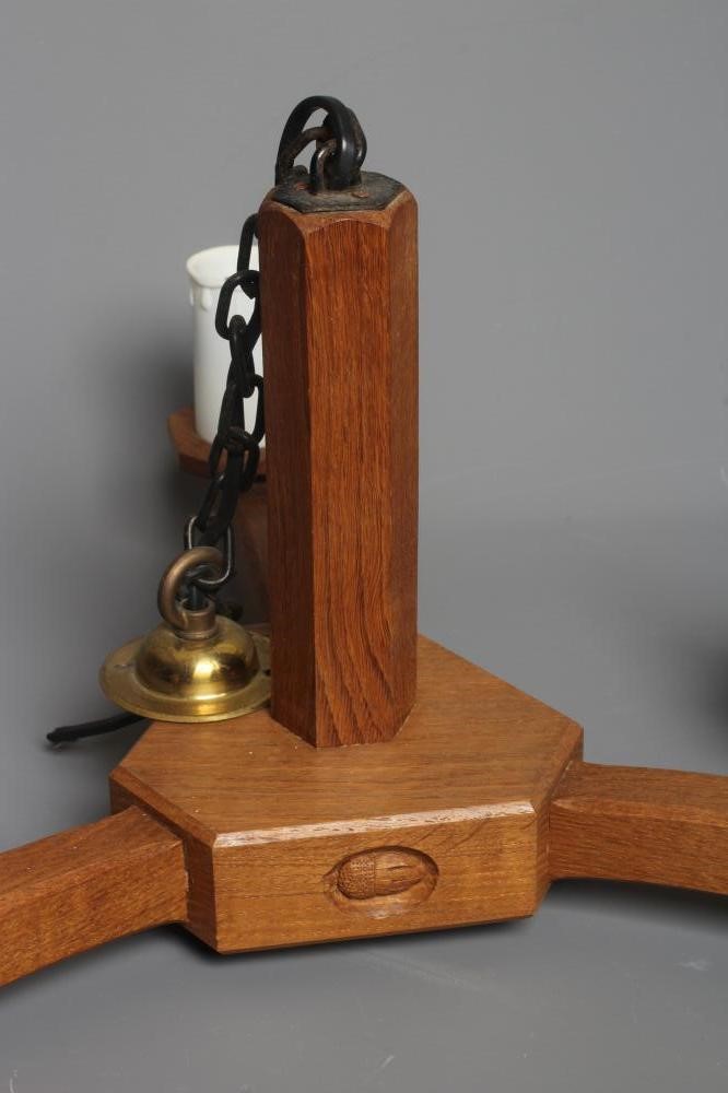 ACORN INDUSTRIES GEORGE GRAINGER - A PAIR OF OAK THREE LIGHT PENDANTS Image