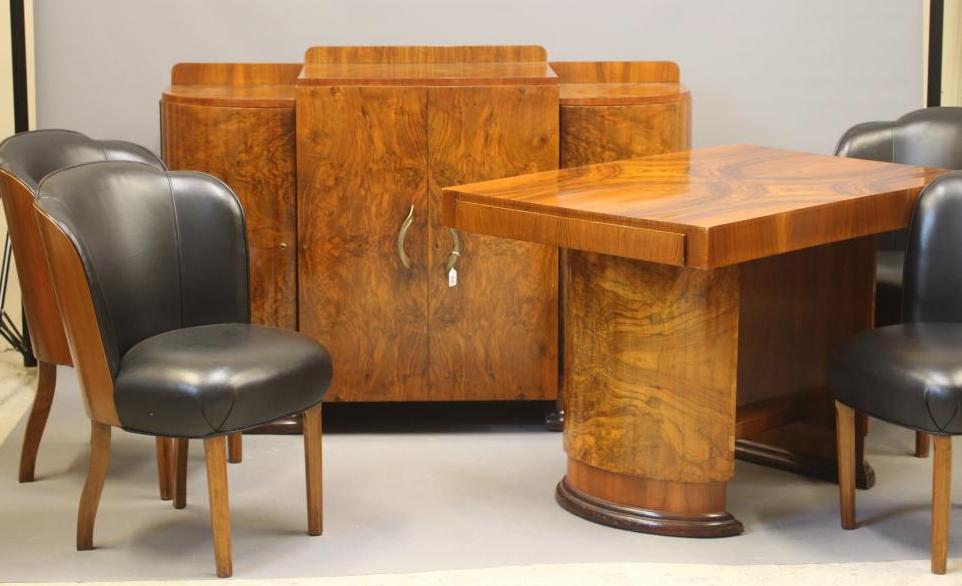 AN ART DECO WALNUT DINING SUITE comprising a draw leaf table with well figured oblong top Image