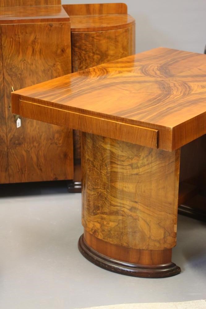 AN ART DECO WALNUT DINING SUITE comprising a draw leaf table with well figured oblong top Image