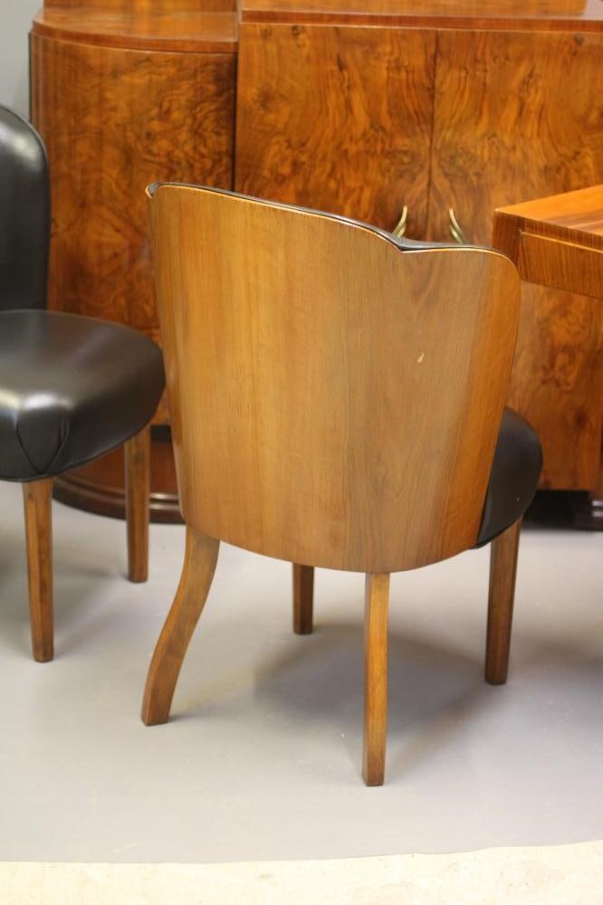 AN ART DECO WALNUT DINING SUITE comprising a draw leaf table with well figured oblong top Image