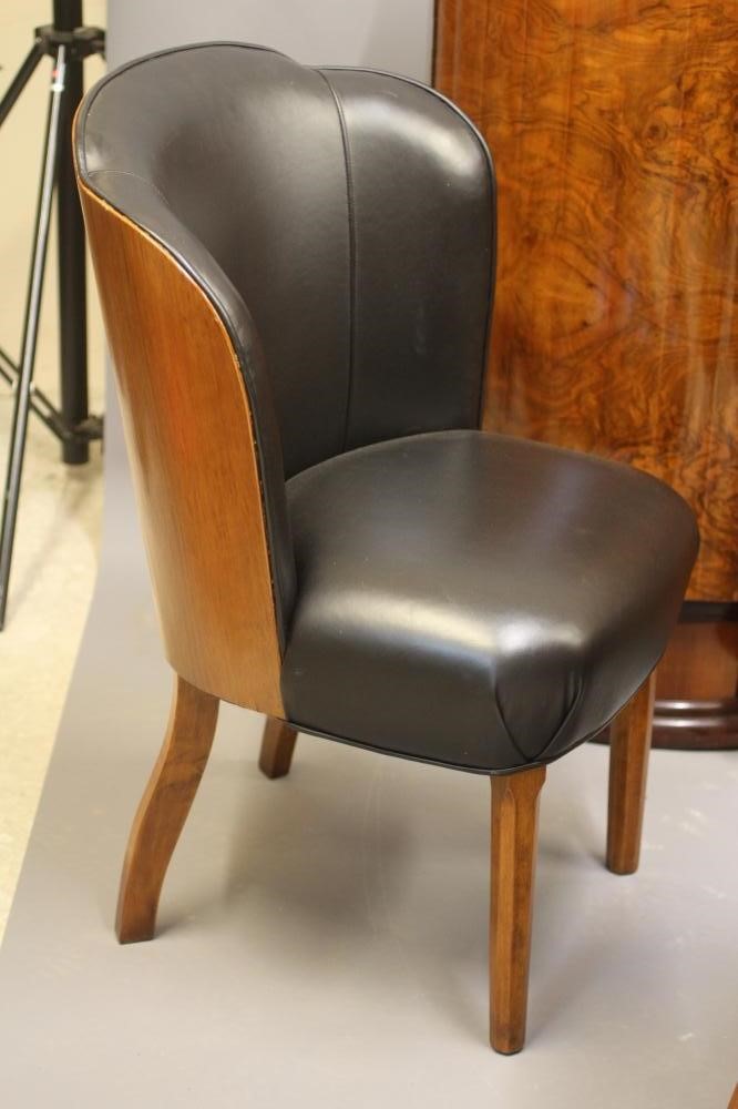AN ART DECO WALNUT DINING SUITE comprising a draw leaf table with well figured oblong top Image