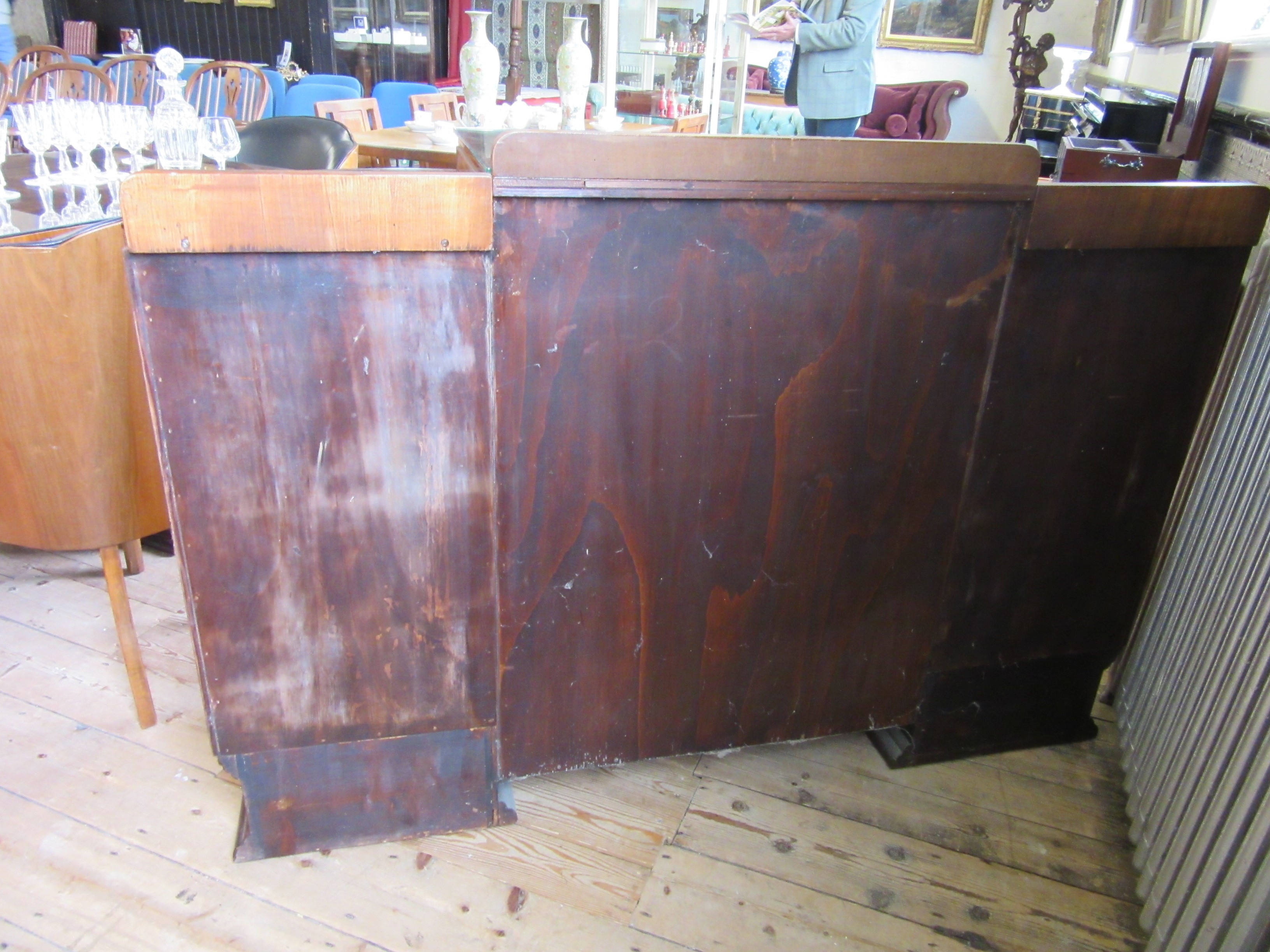 AN ART DECO WALNUT DINING SUITE comprising a draw leaf table with well figured oblong top Image