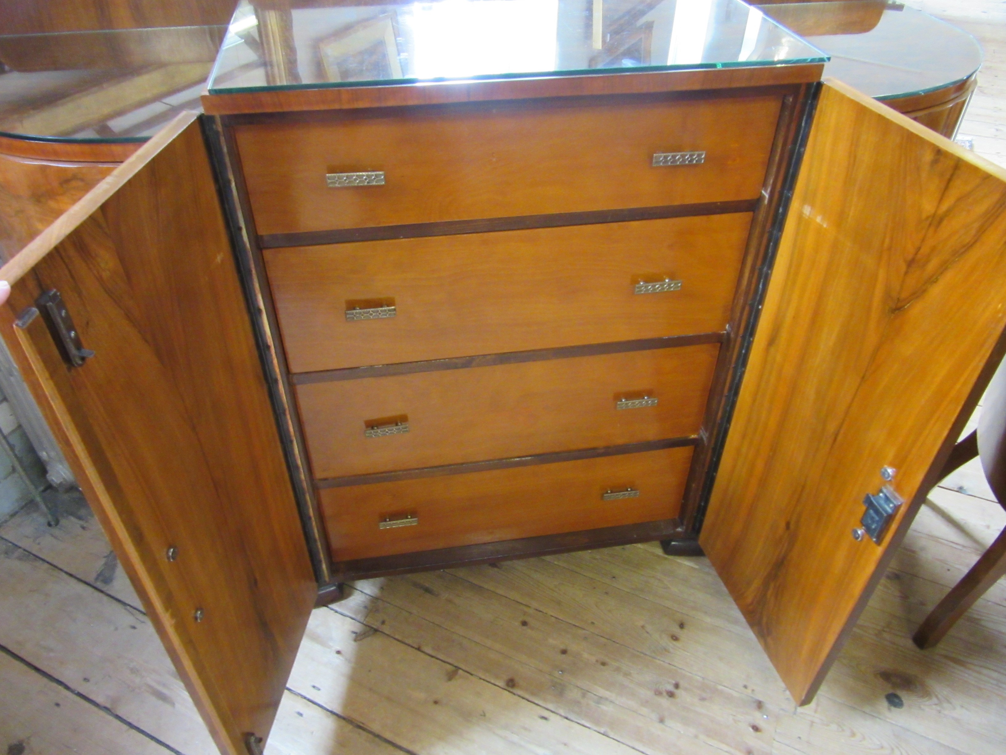 AN ART DECO WALNUT DINING SUITE comprising a draw leaf table with well figured oblong top Image