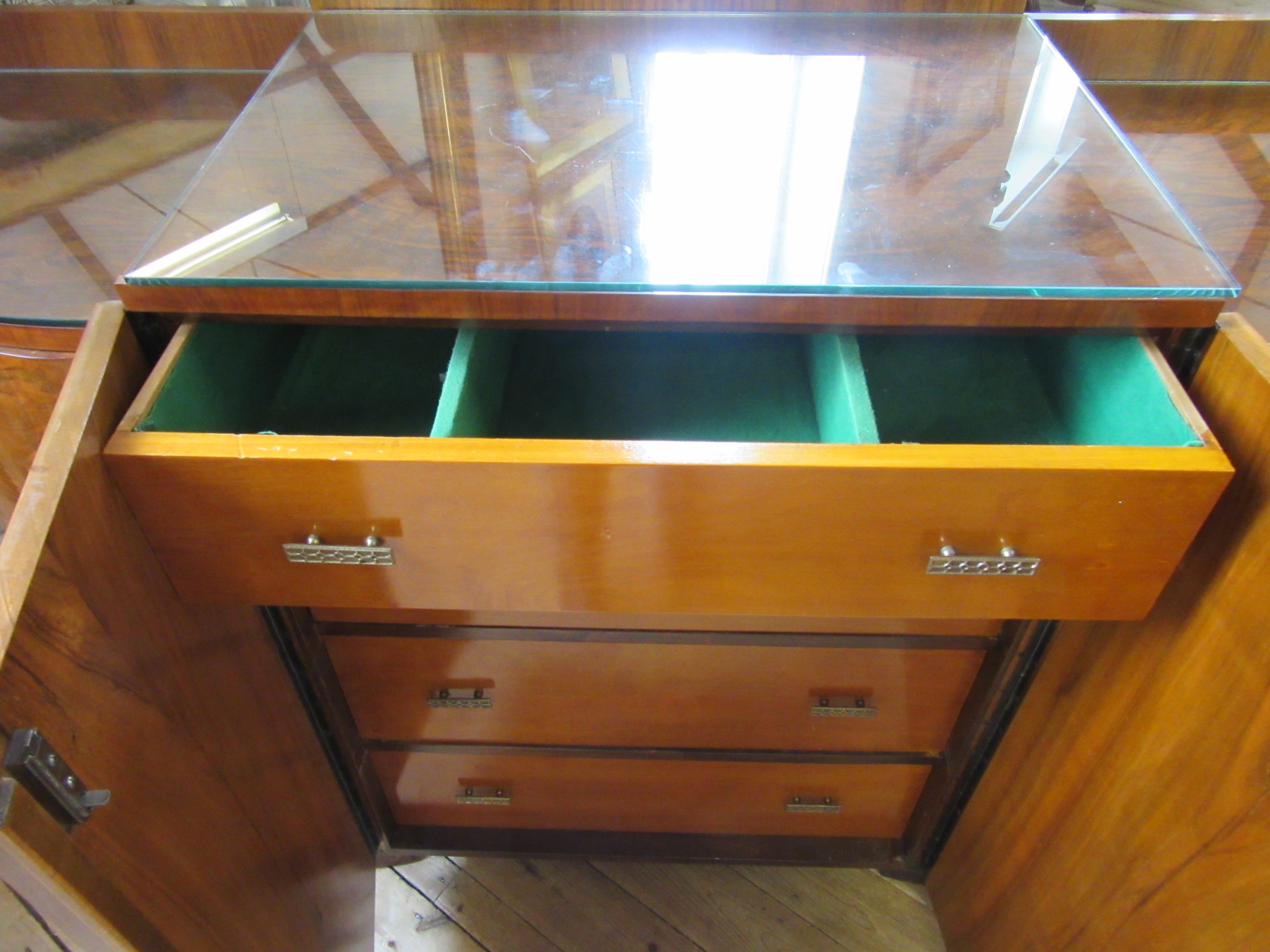 AN ART DECO WALNUT DINING SUITE comprising a draw leaf table with well figured oblong top Image