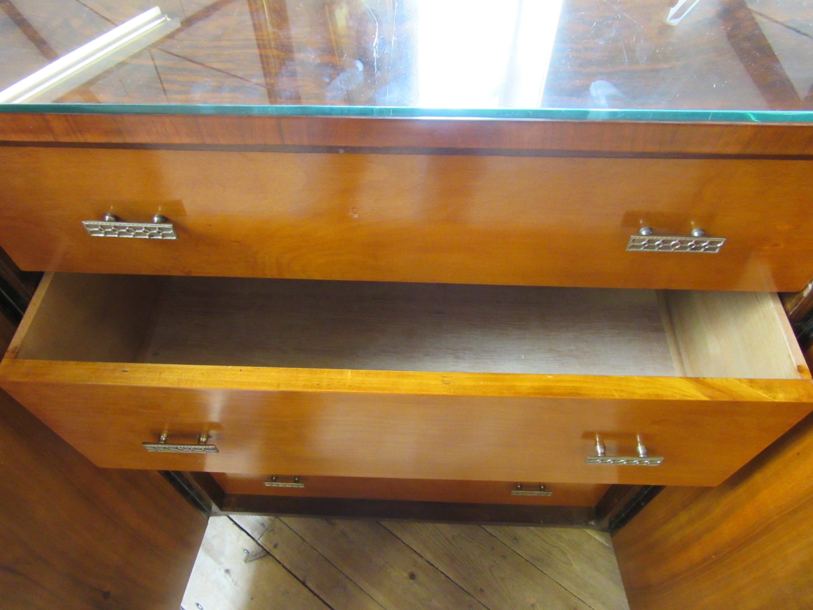 AN ART DECO WALNUT DINING SUITE comprising a draw leaf table with well figured oblong top Image