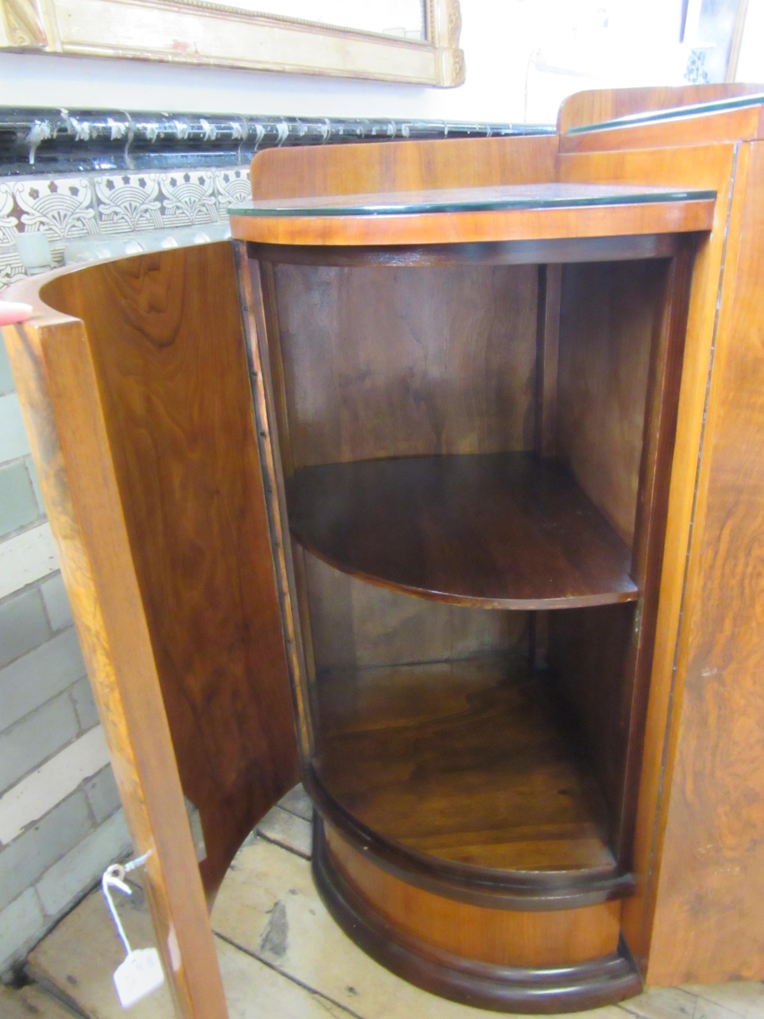 AN ART DECO WALNUT DINING SUITE comprising a draw leaf table with well figured oblong top Image