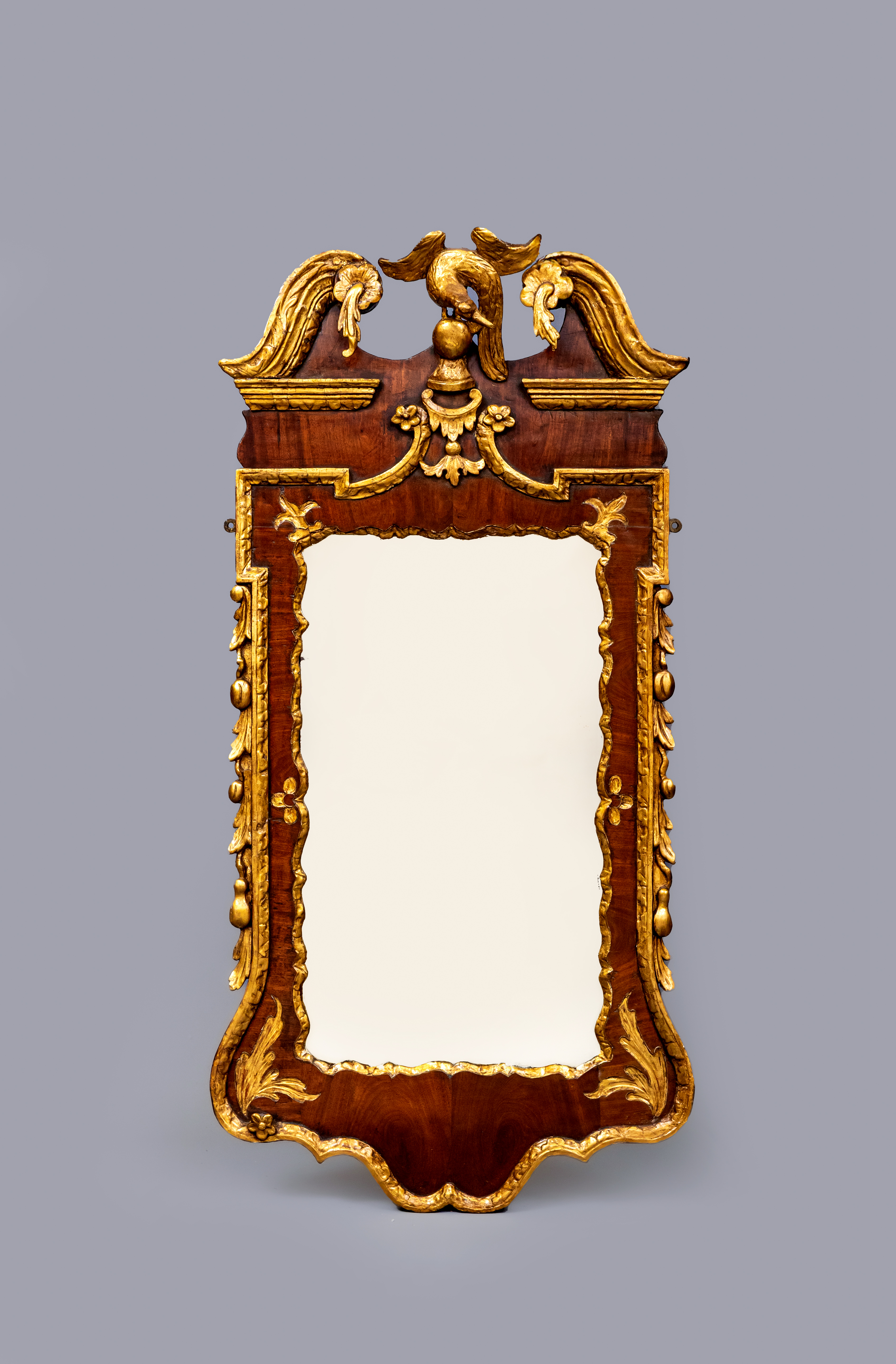 A GEORGIAN WALNUT AND PARCEL GILT PIER GLASS in the manner of William Kent Image