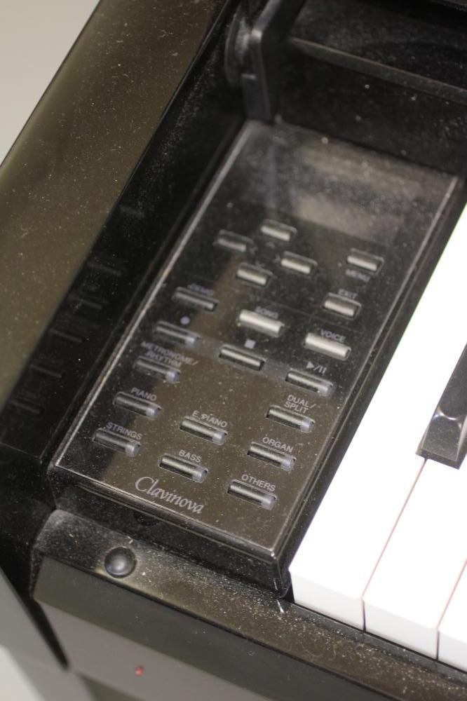 A YAMAHA "CLAVINOVA" ELECTRIC PIANO, modern, in upright ebonised case, 57 3/4" w x 18 3/4" d x 40" Image