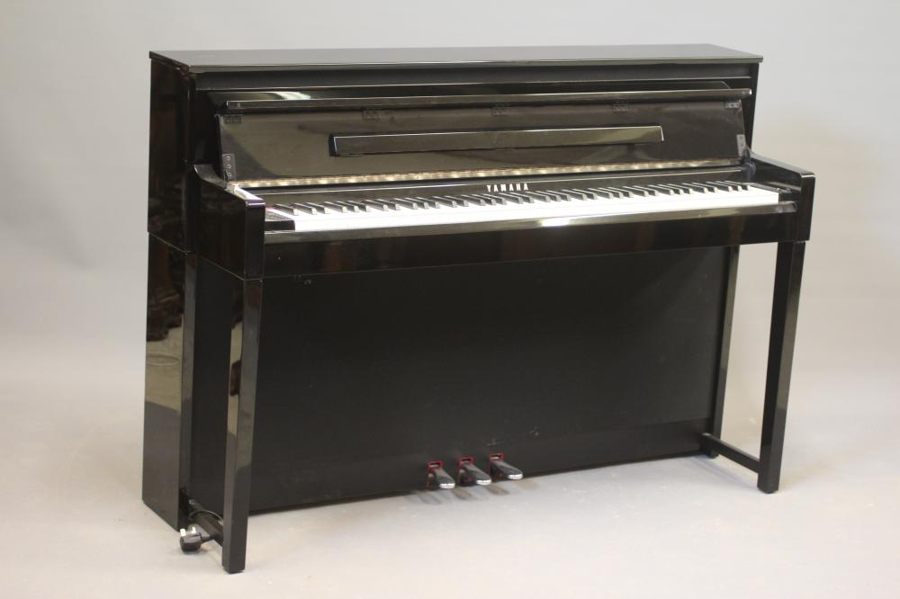 A YAMAHA "CLAVINOVA" ELECTRIC PIANO, modern, in upright ebonised case, 57 3/4" w x 18 3/4" d x 40" Image