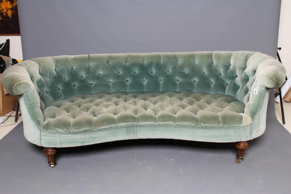 A VICTORIAN WALNUT FRAMED CHESTERFIELD SOFA of curved outline button upholstered in pale green Image