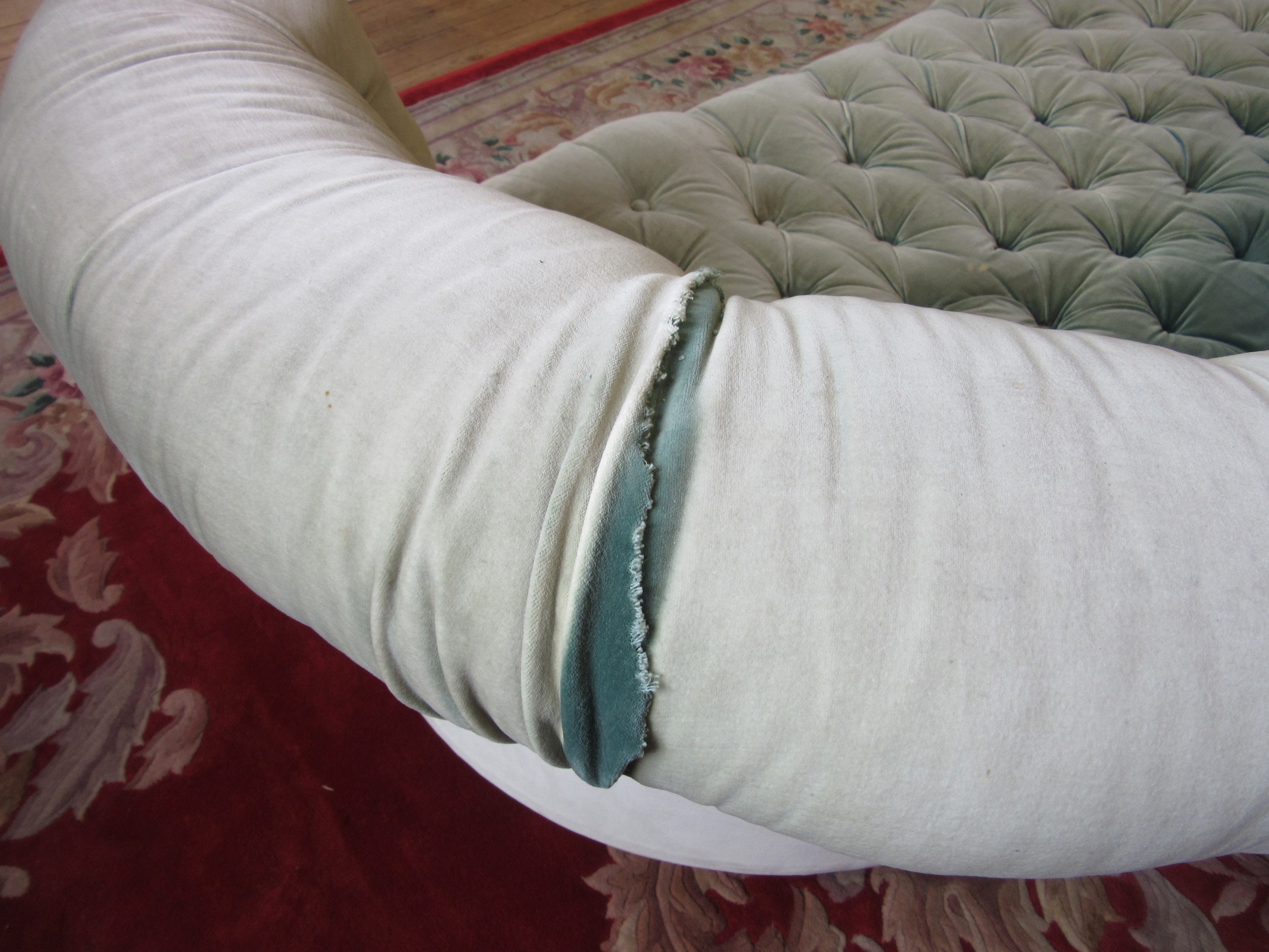 A VICTORIAN WALNUT FRAMED CHESTERFIELD SOFA of curved outline button upholstered in pale green Image