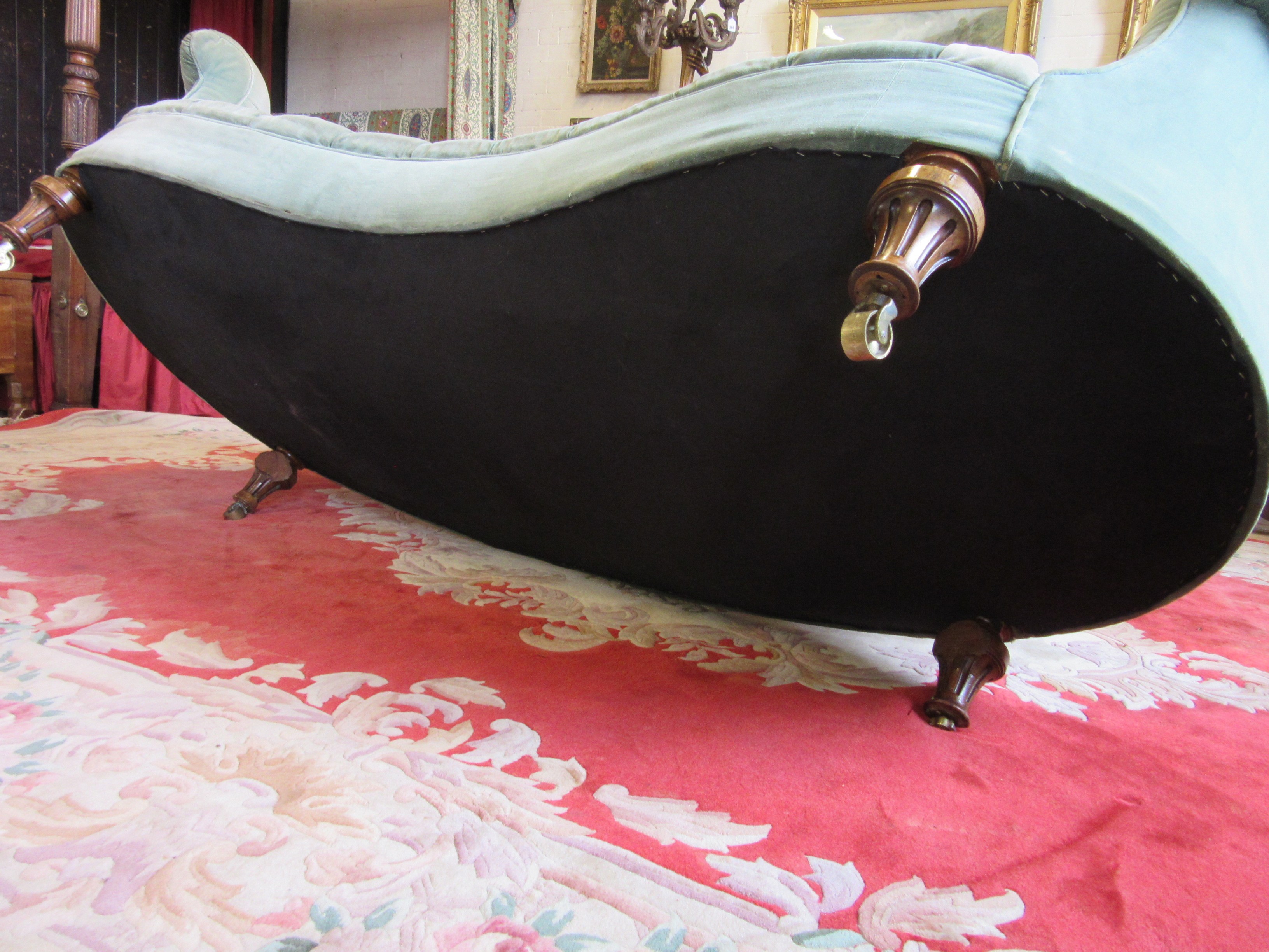 A VICTORIAN WALNUT FRAMED CHESTERFIELD SOFA of curved outline button upholstered in pale green Image